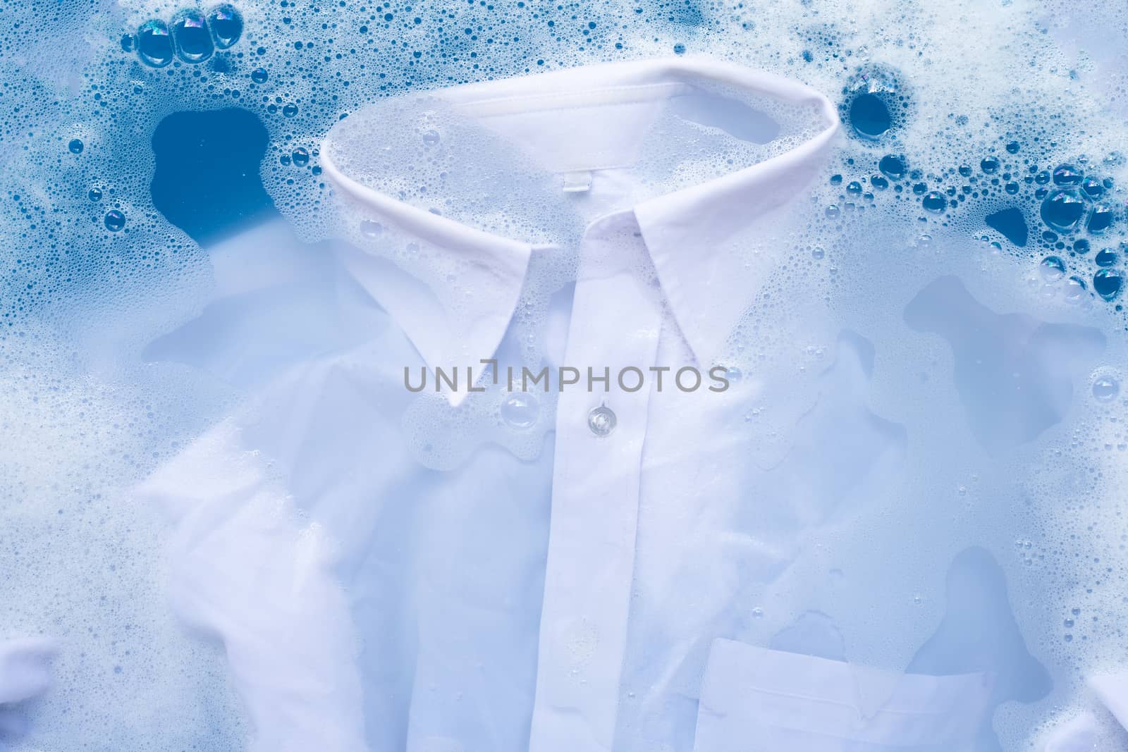 White shirt soak in powder detergent water dissolution, washing  cloth. Laundry concept