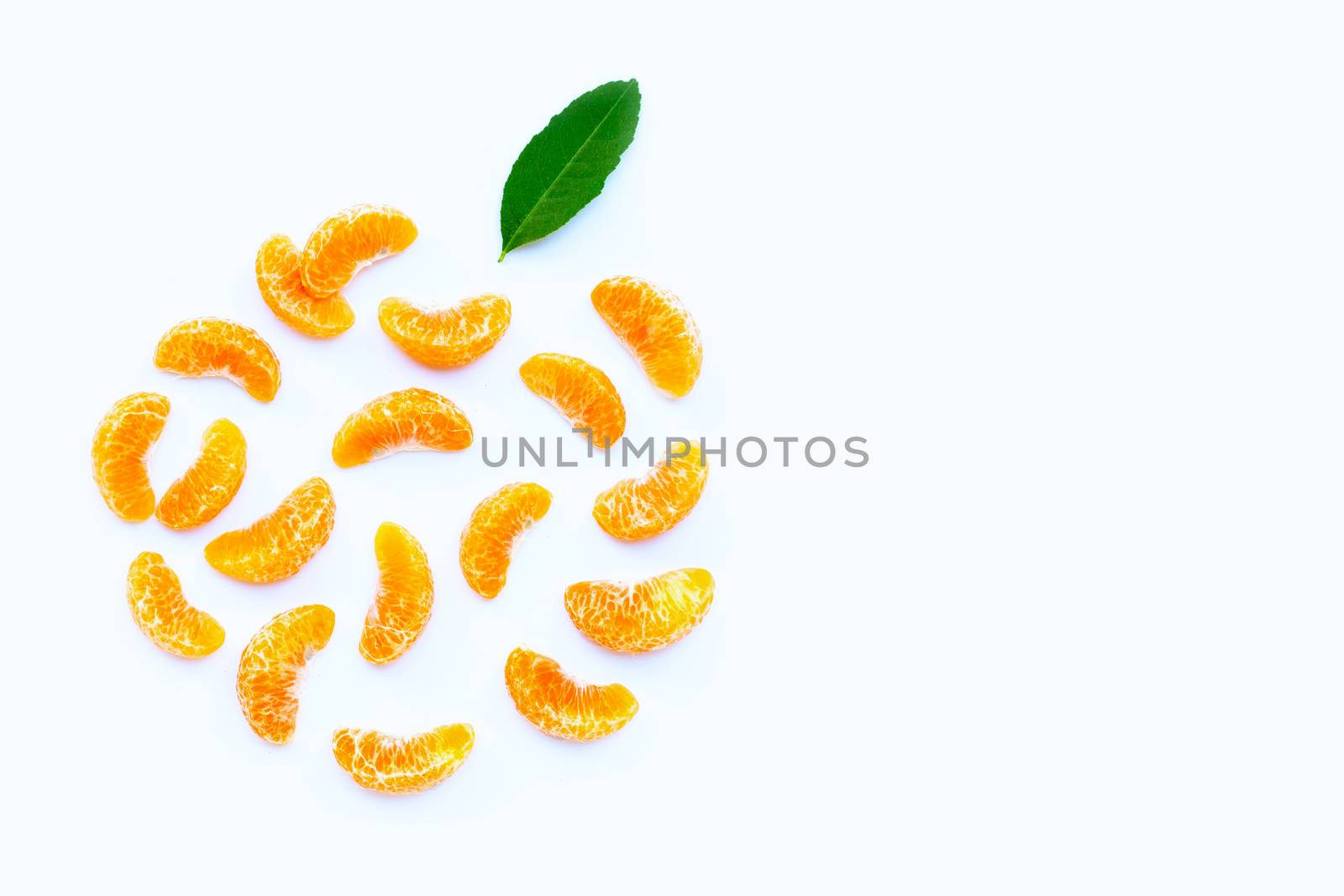 Orange segments with leaf on white background.  Copy  space