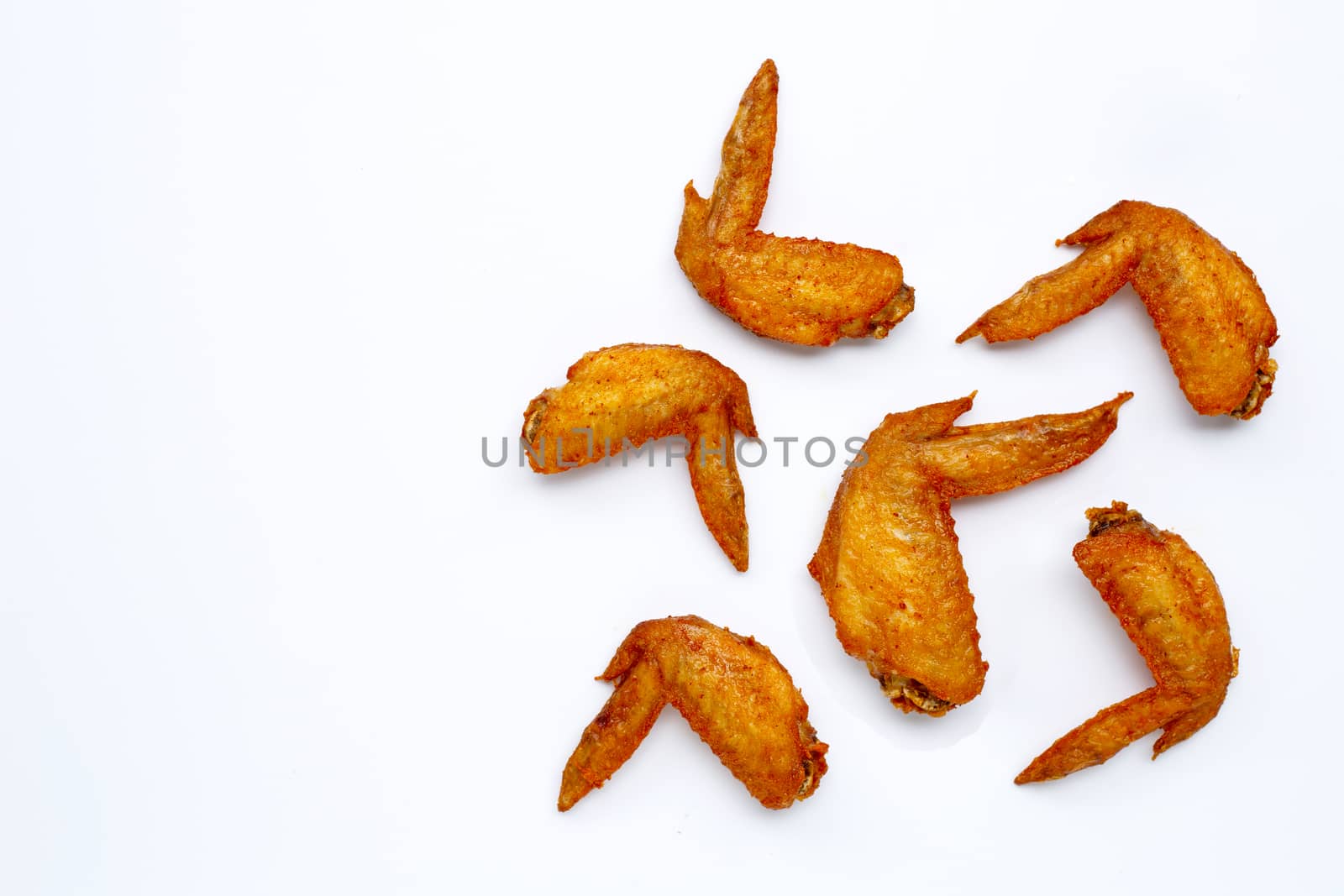 Fried chicken wings on white background.  Copy space