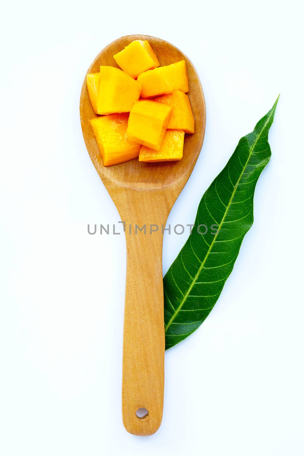 Tropical fruit, Mango on wooden spoon, white background.  by Bowonpat