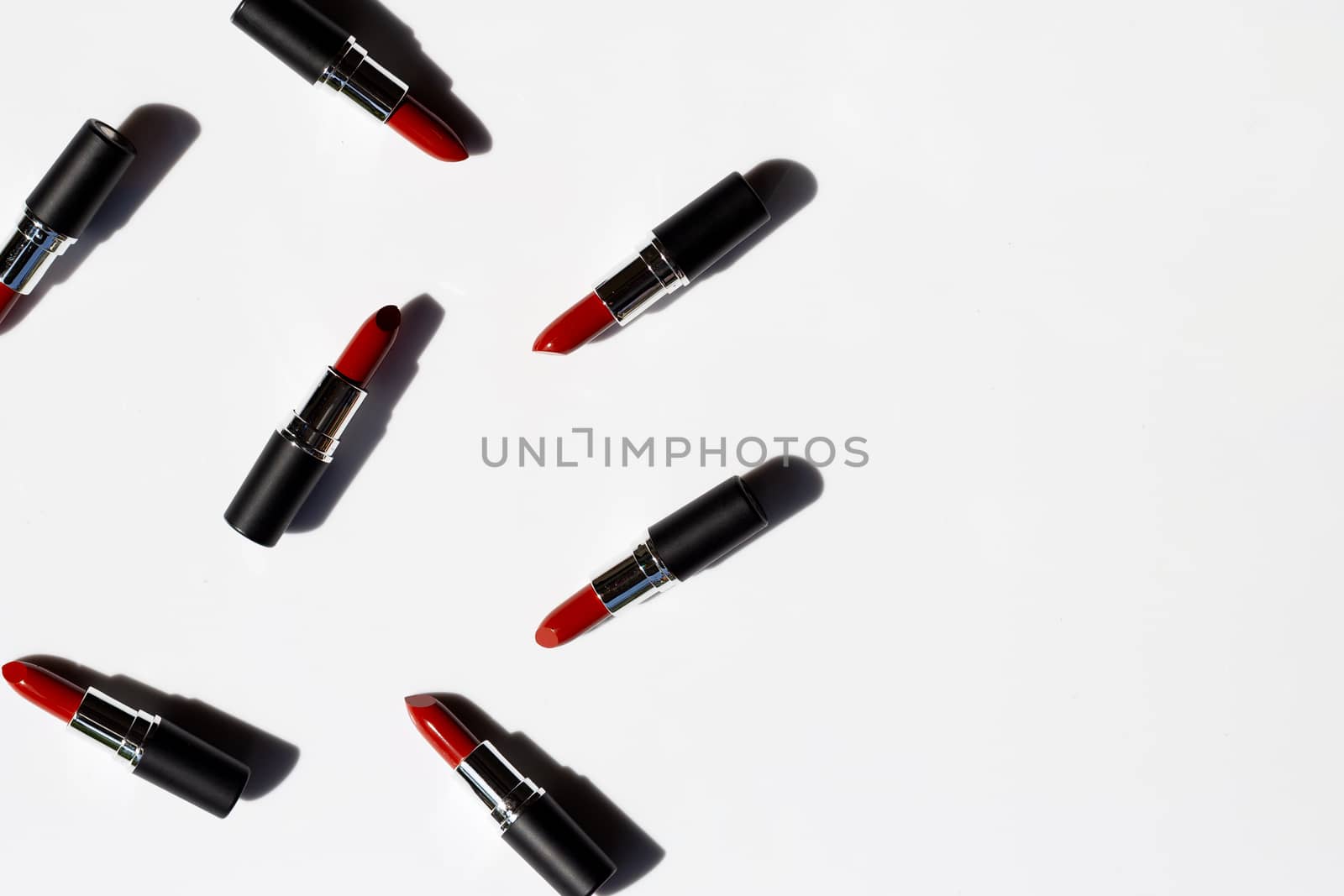 Flat lay composition, Lipsticks on white background with shadow. Beautiful Make-up concept