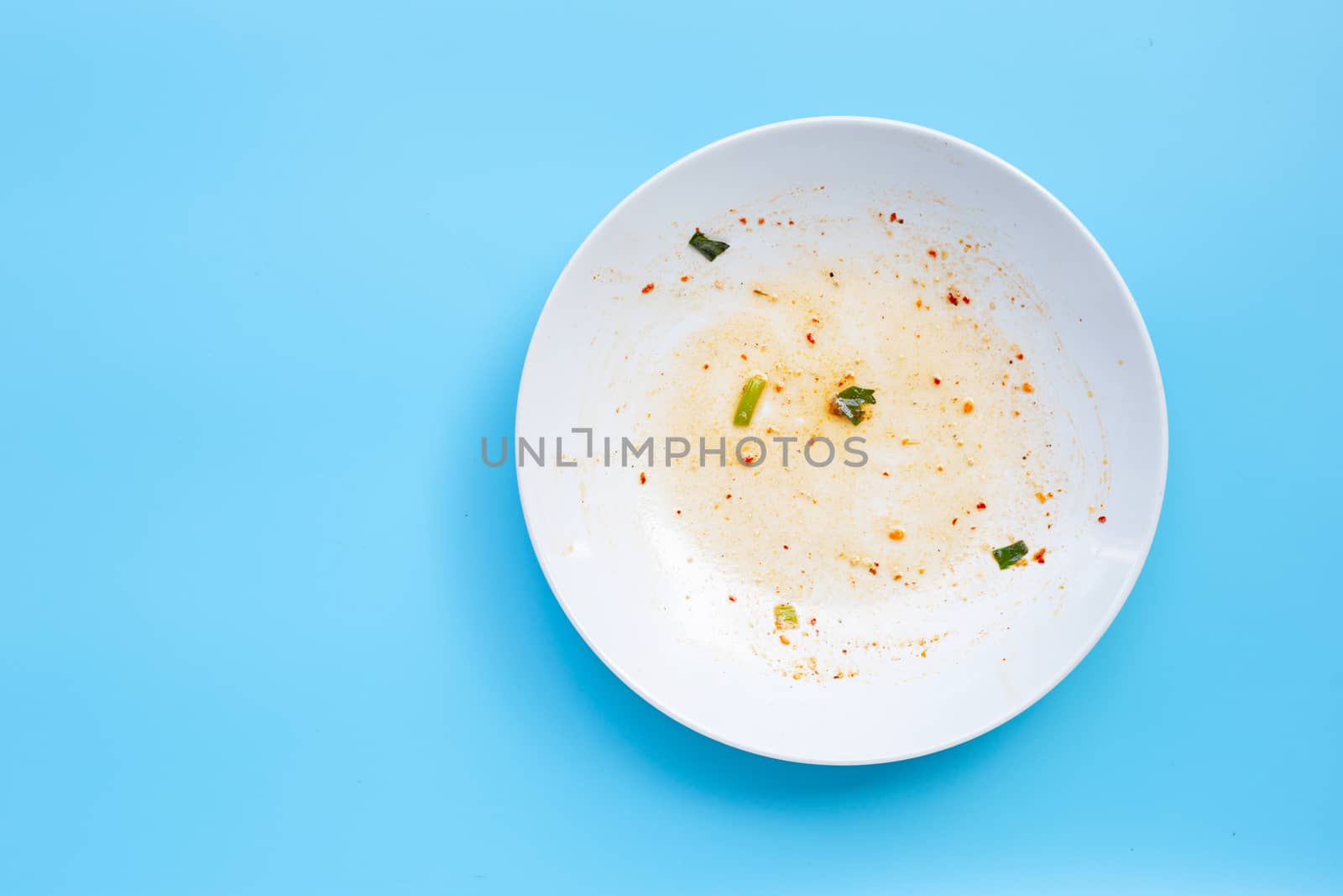 Dirty dish on blue background. Top view