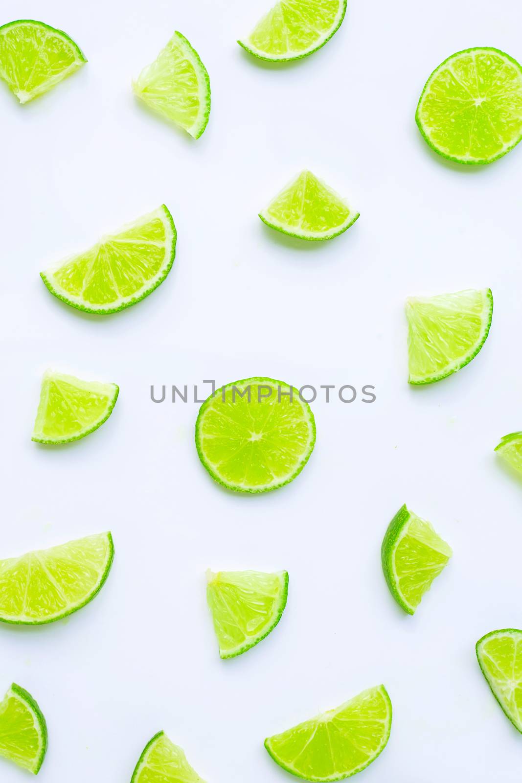 Lime slices on white background. by Bowonpat