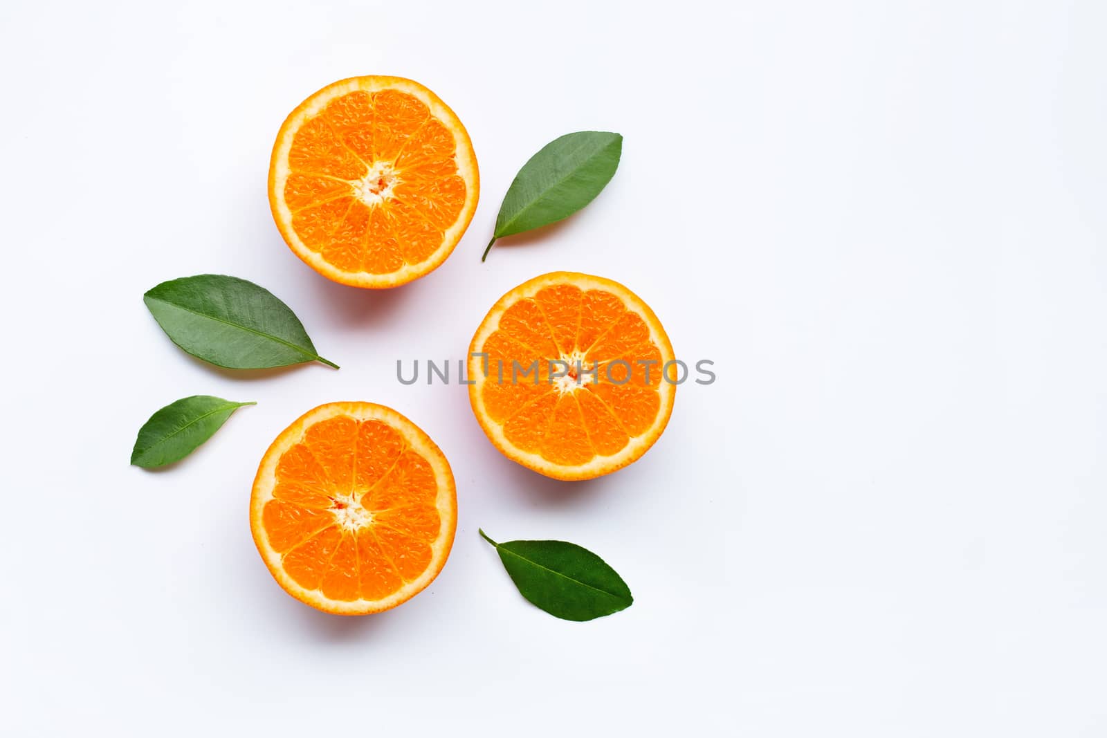 Fresh orange citrus fruits with leaves on white background.  Top view with copy space