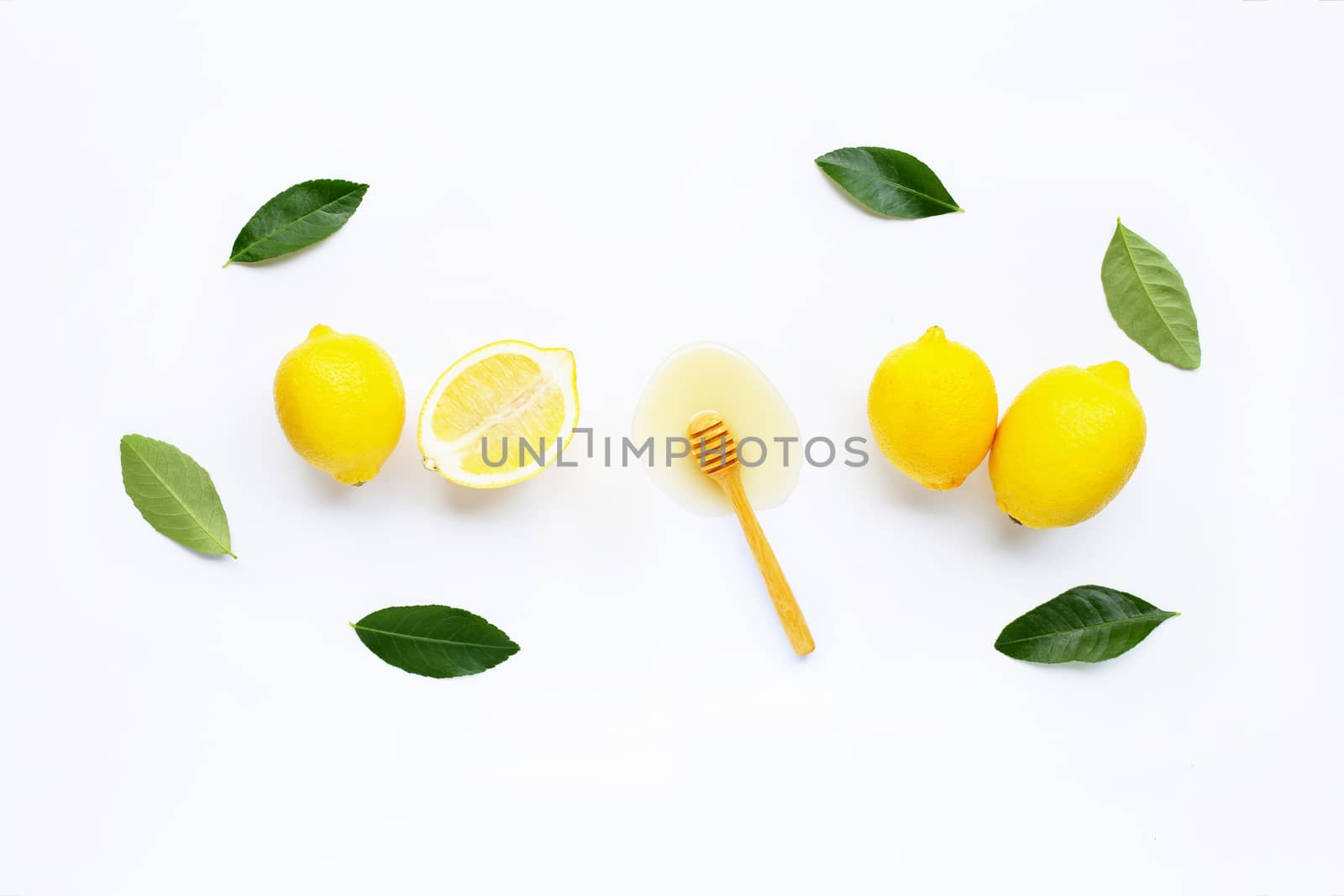 Fresh lemon with honey on white background.