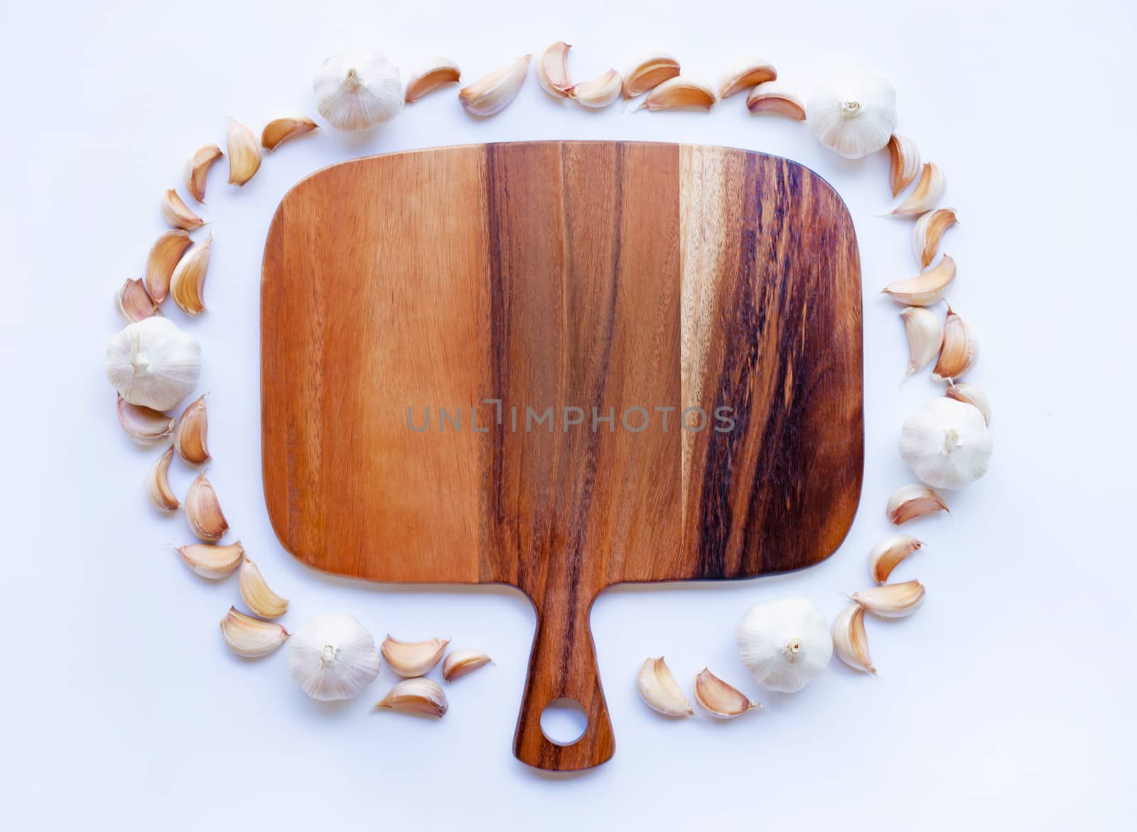 Garlic with wooden cutting board on white background