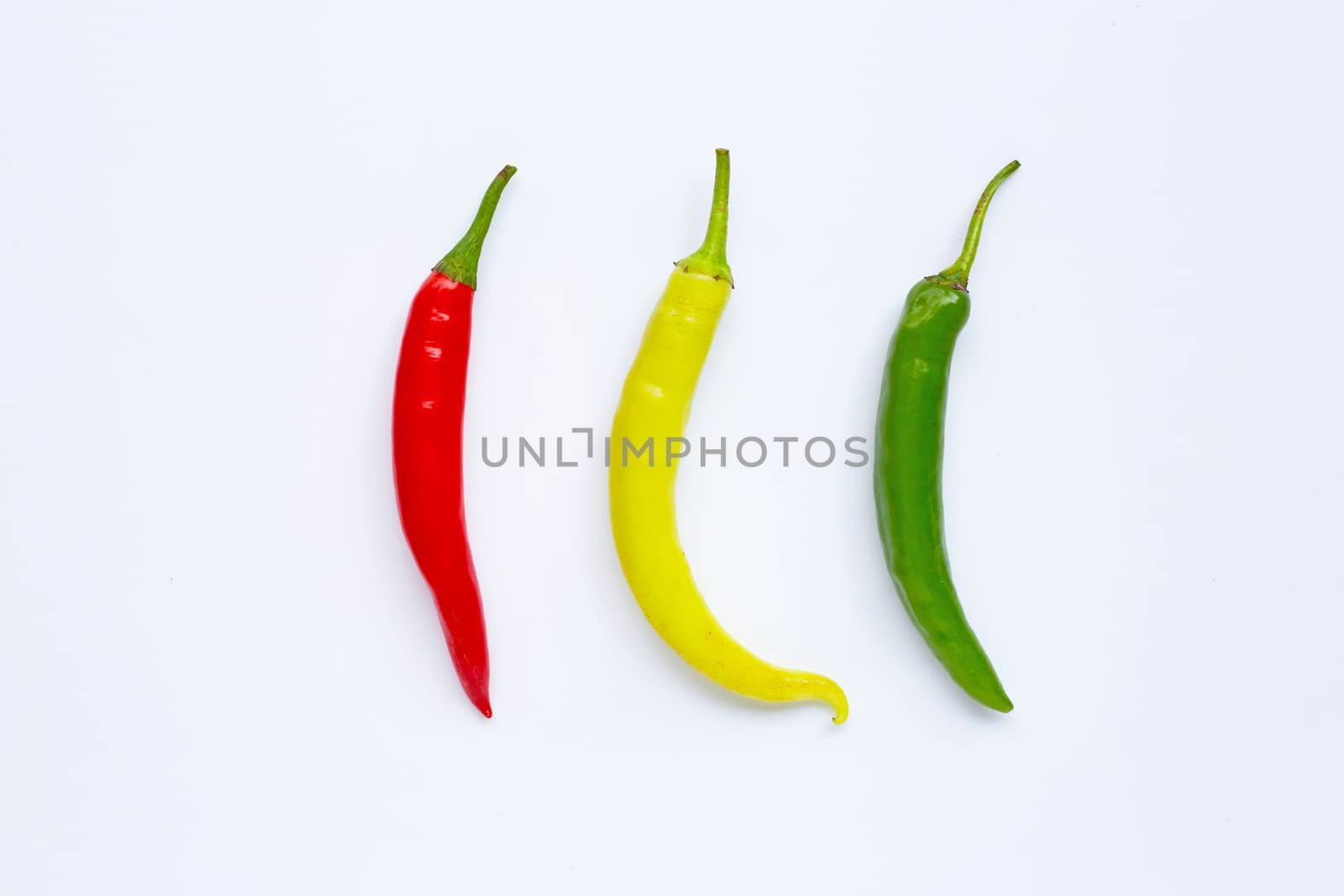 Different colors chili peppers isolated on white background