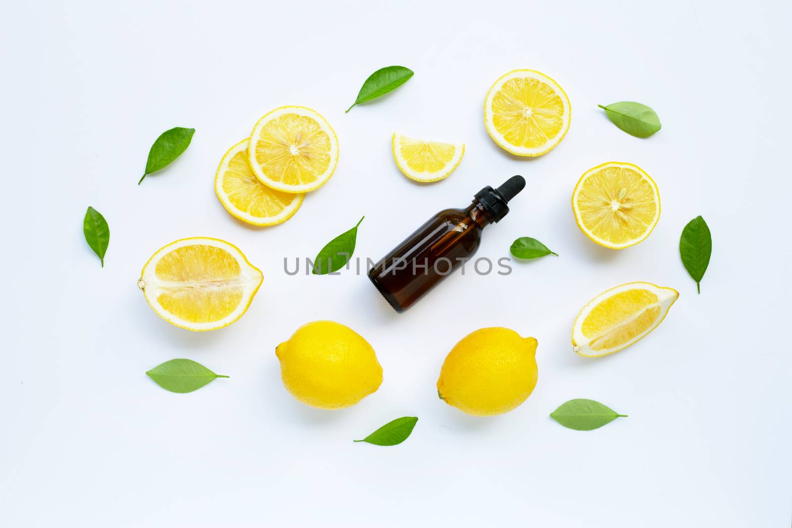 Fresh lemon with lemon essential oil on a white background.