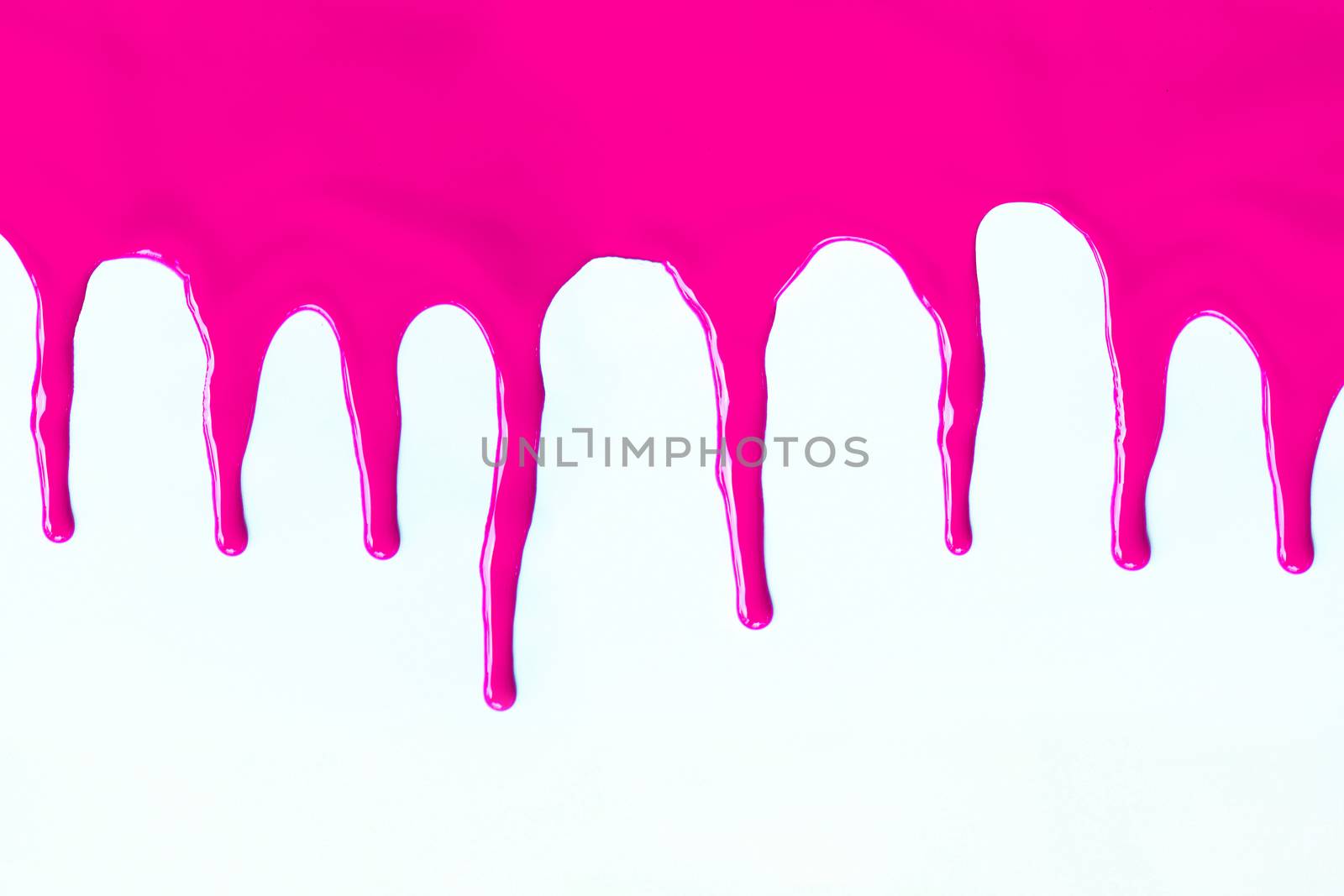 Pink paint dripping on a white background