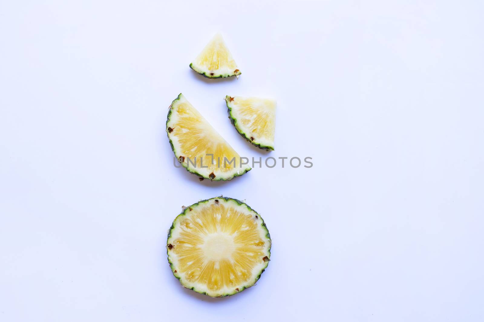 Pineapple slices on white background.