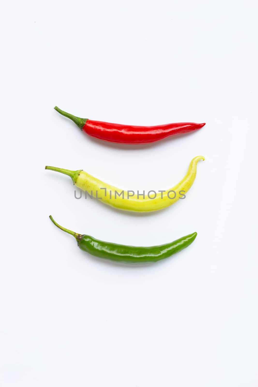 Different colors chili peppers isolated on white background