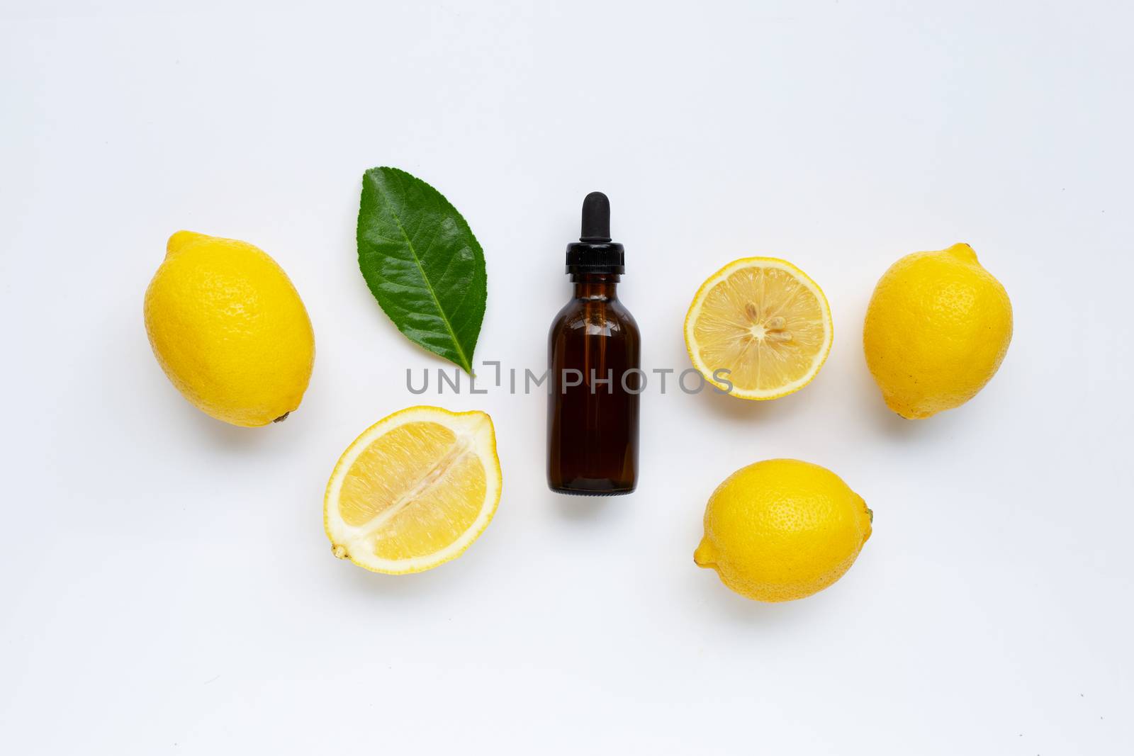 Fresh lemon with lemon essential oil on  white background.