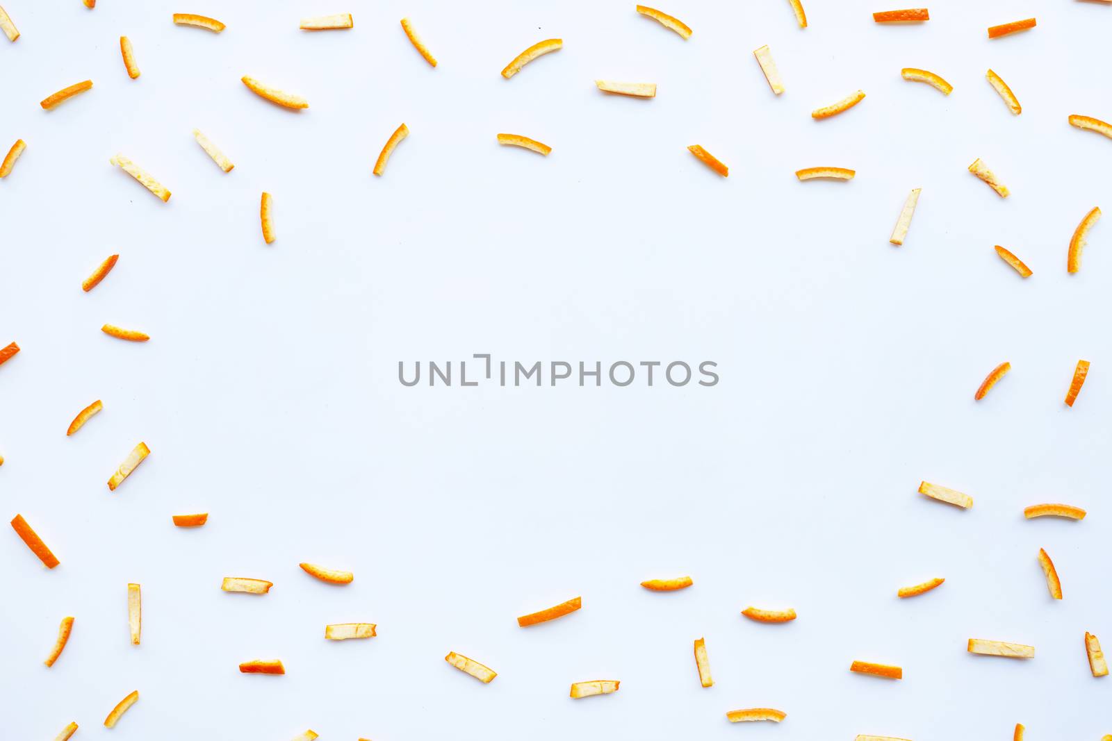 Frame made of orange peels on white background. top view