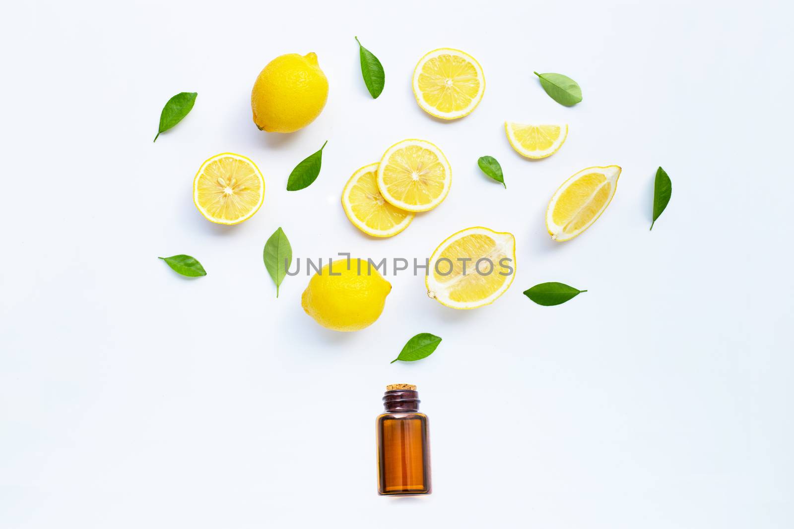 Lemon and slices with  essential oil isolated on white background.