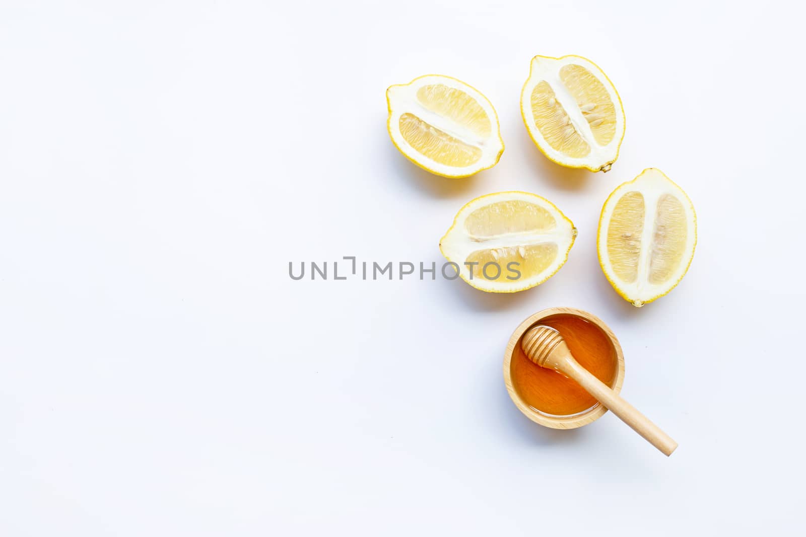 Honey with lemon on white background. Copy space