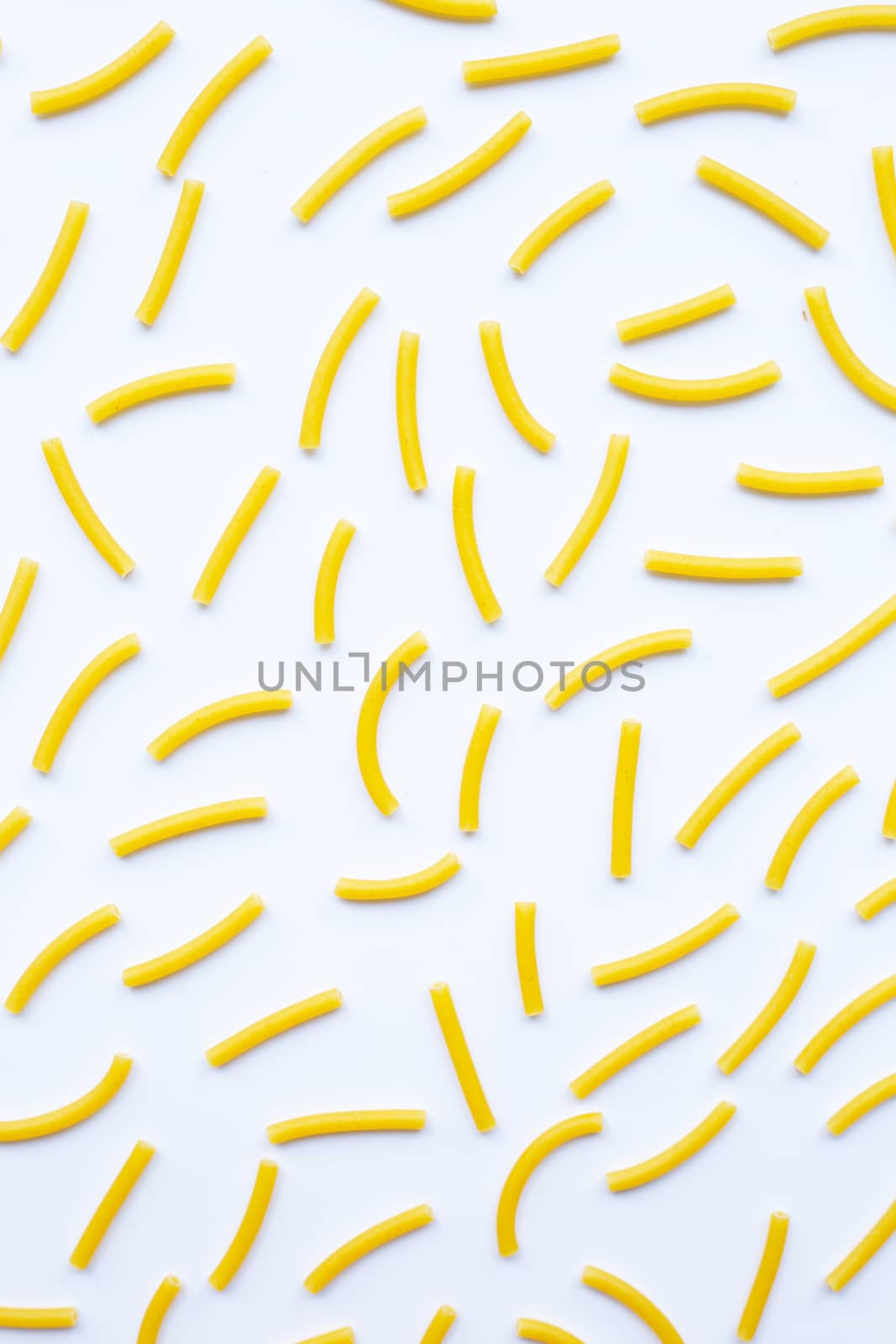 Uncooked macaroni on a white background.