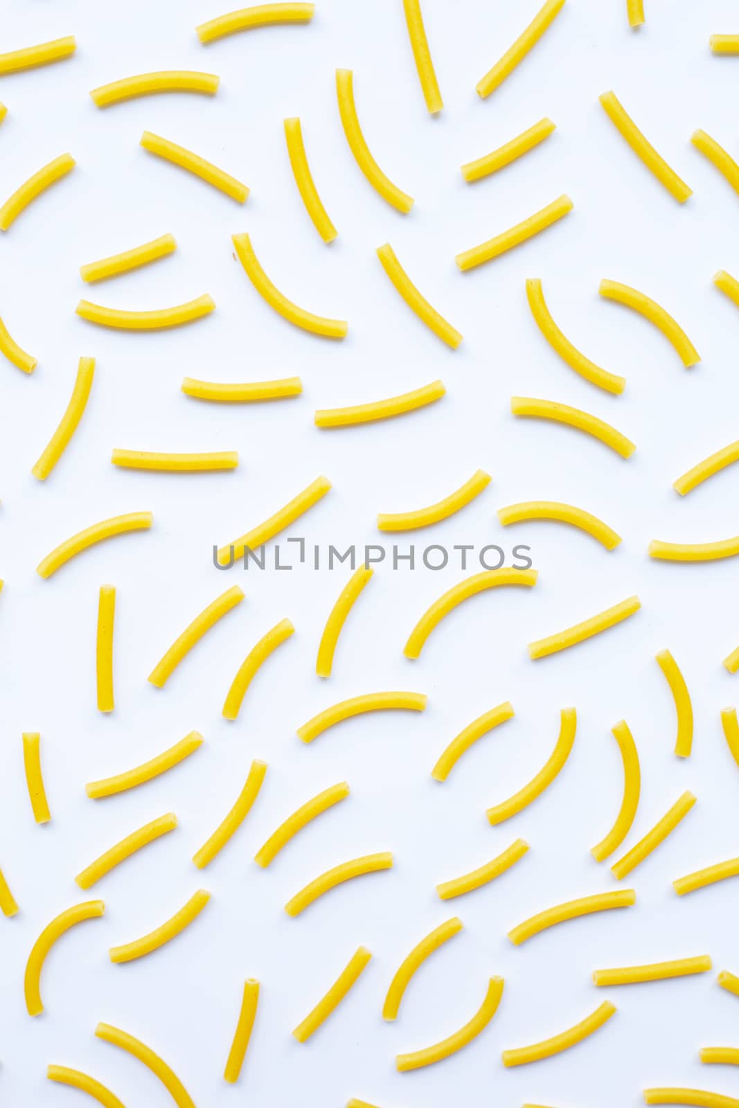 Uncooked macaroni on a white background.