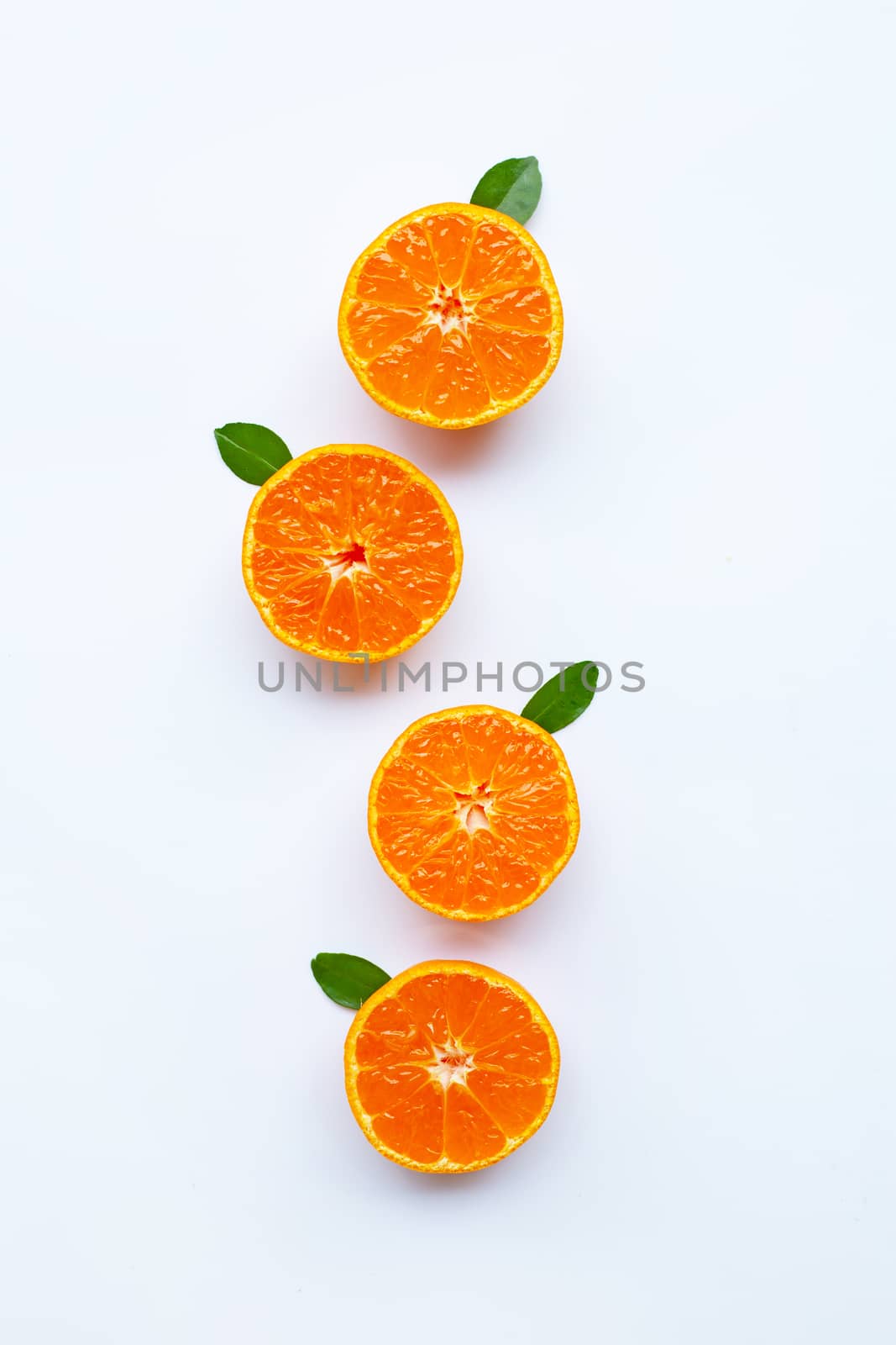 Orange fruits and green leaves on a white background.  by Bowonpat