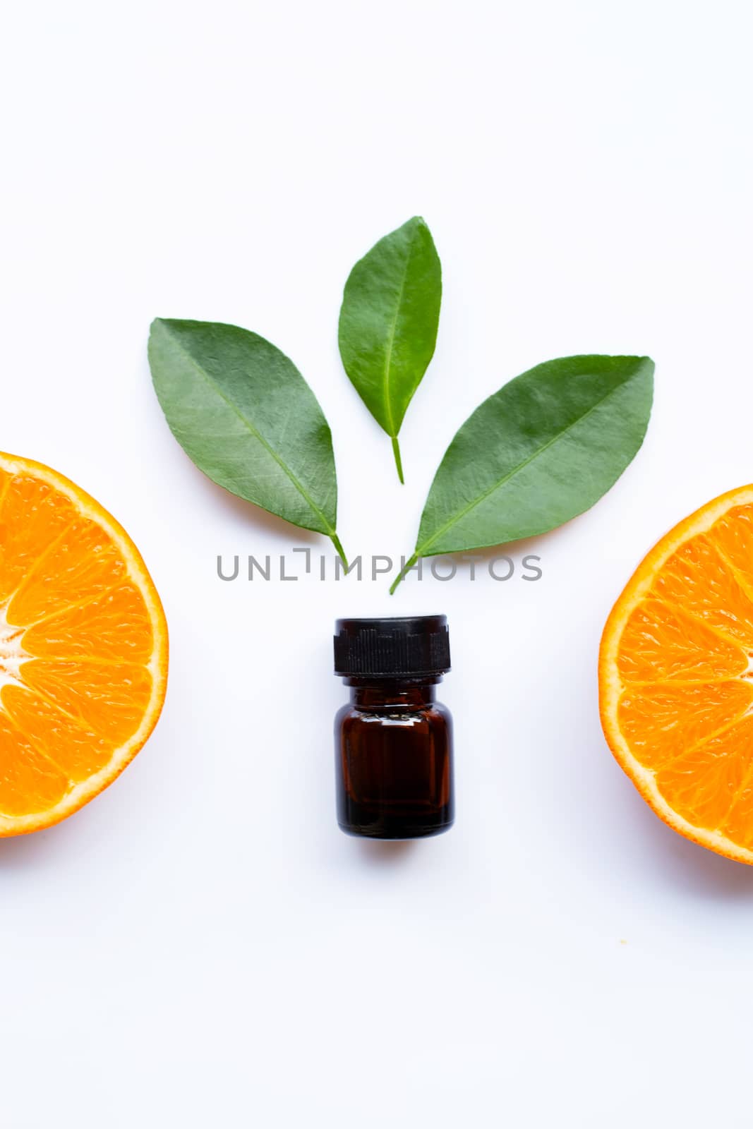 Essential oil of orange on white background.