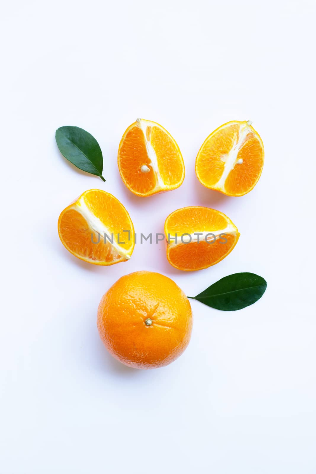 Fresh orange citrus fruit with green leaves on white background. 