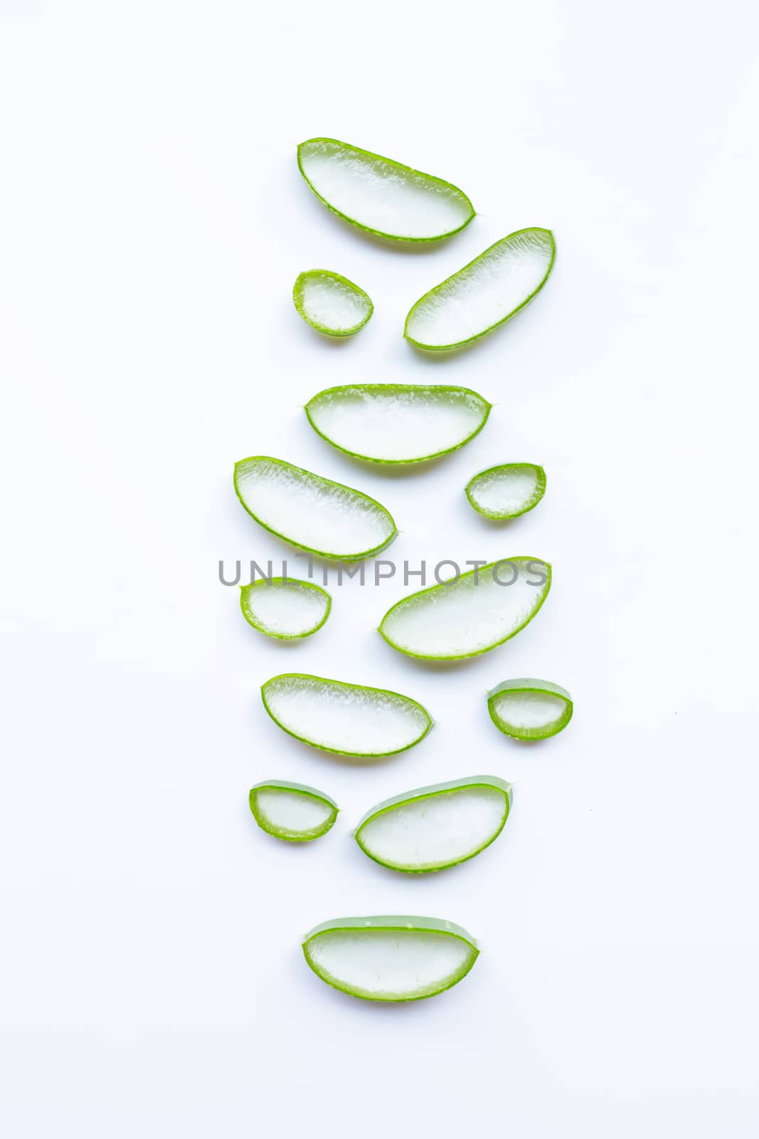 Aloe vera slices on white background.