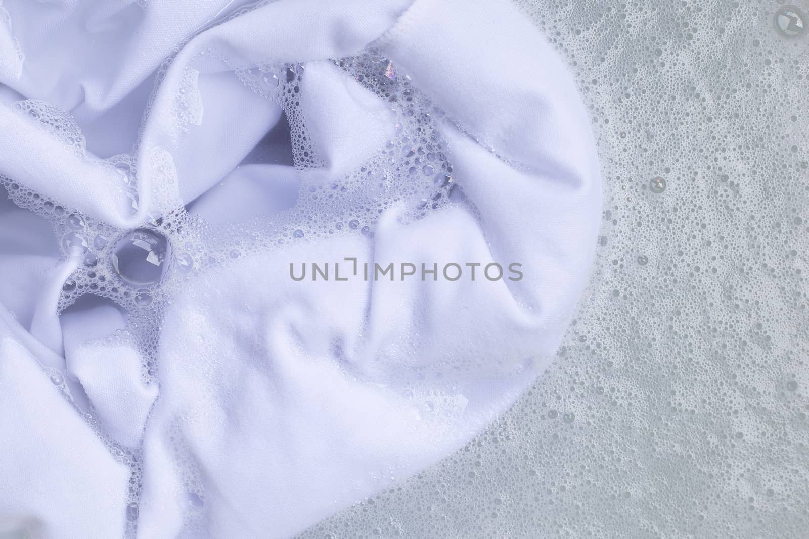 Soak a cloth before washing, white cloth. Top view