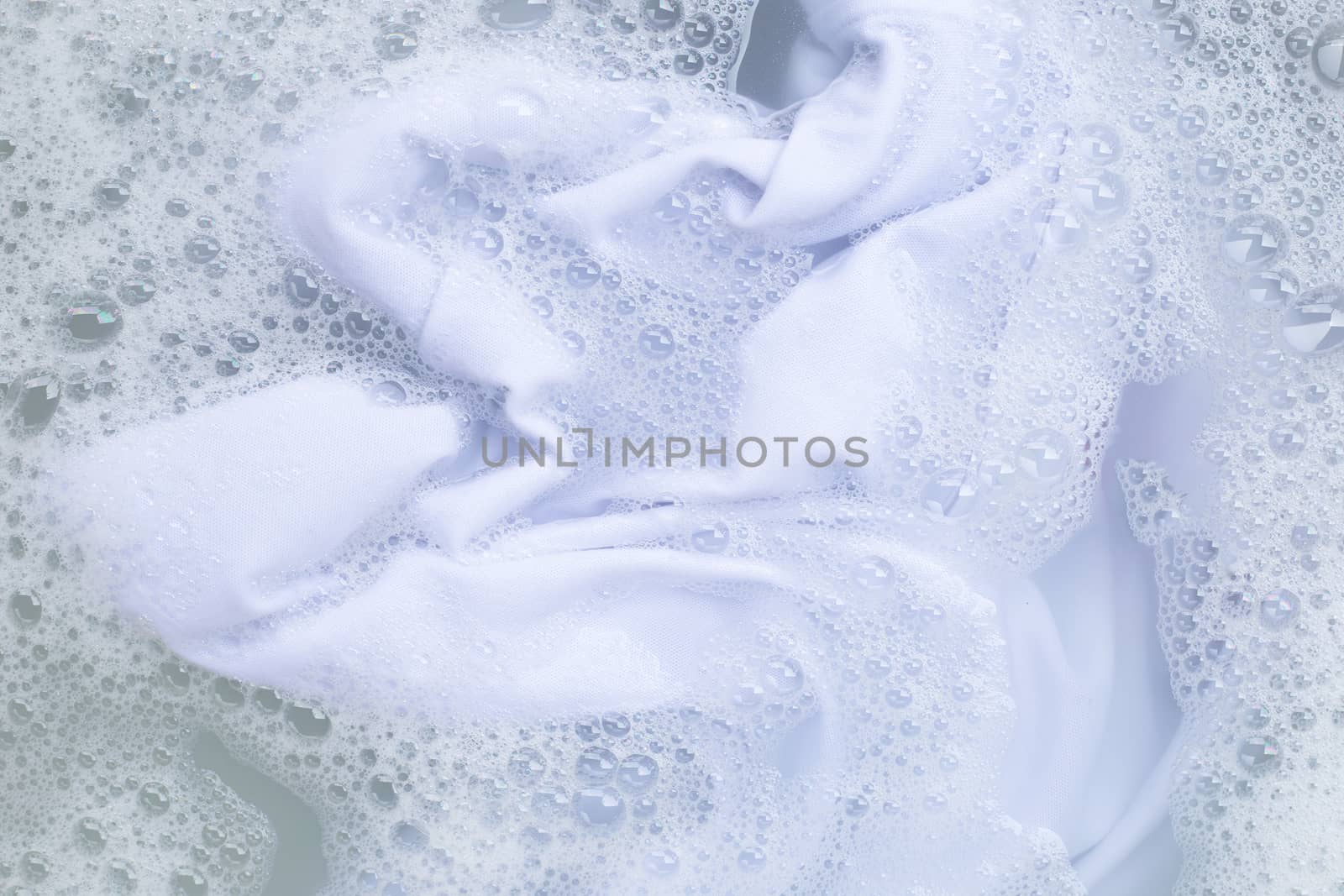 Soak a cloth before washing, white cloth by Bowonpat