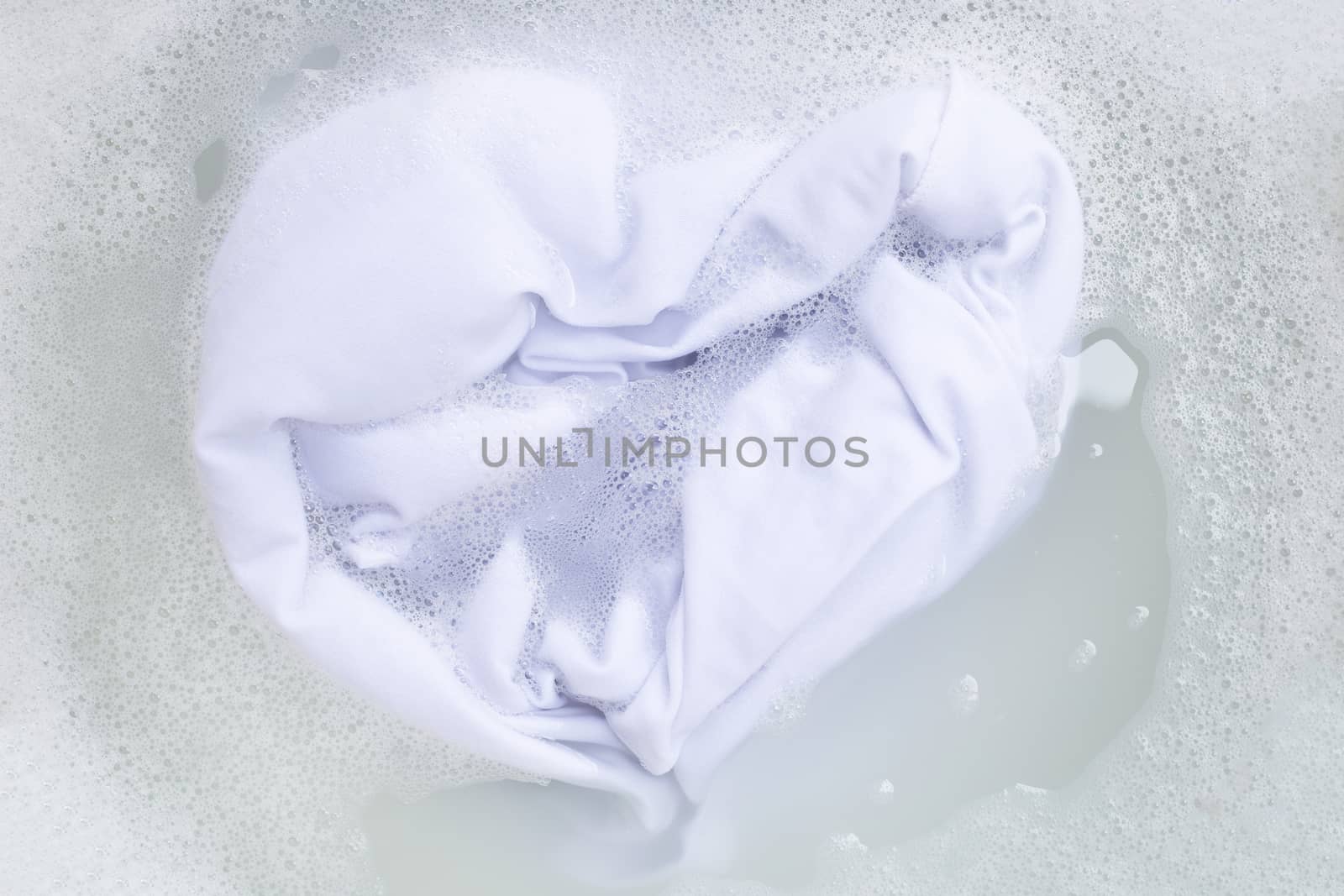 Soak a cloth before washing, white cloth. Top view