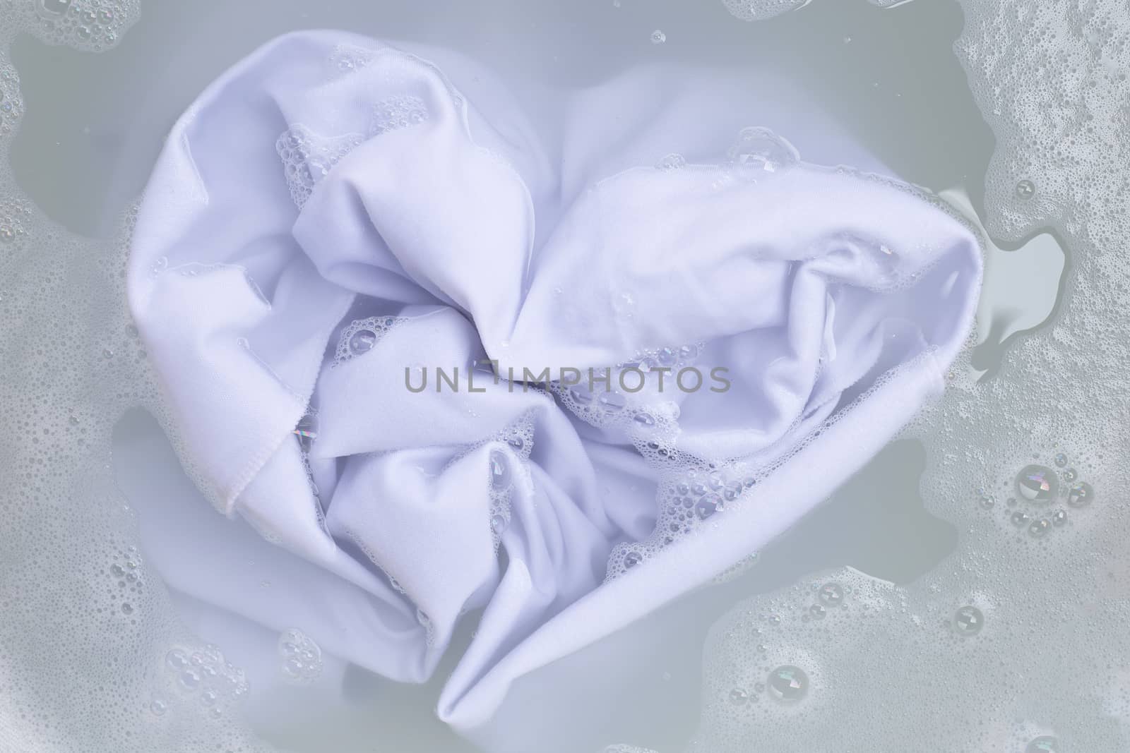 Soak a cloth before washing, white cloth. Top view