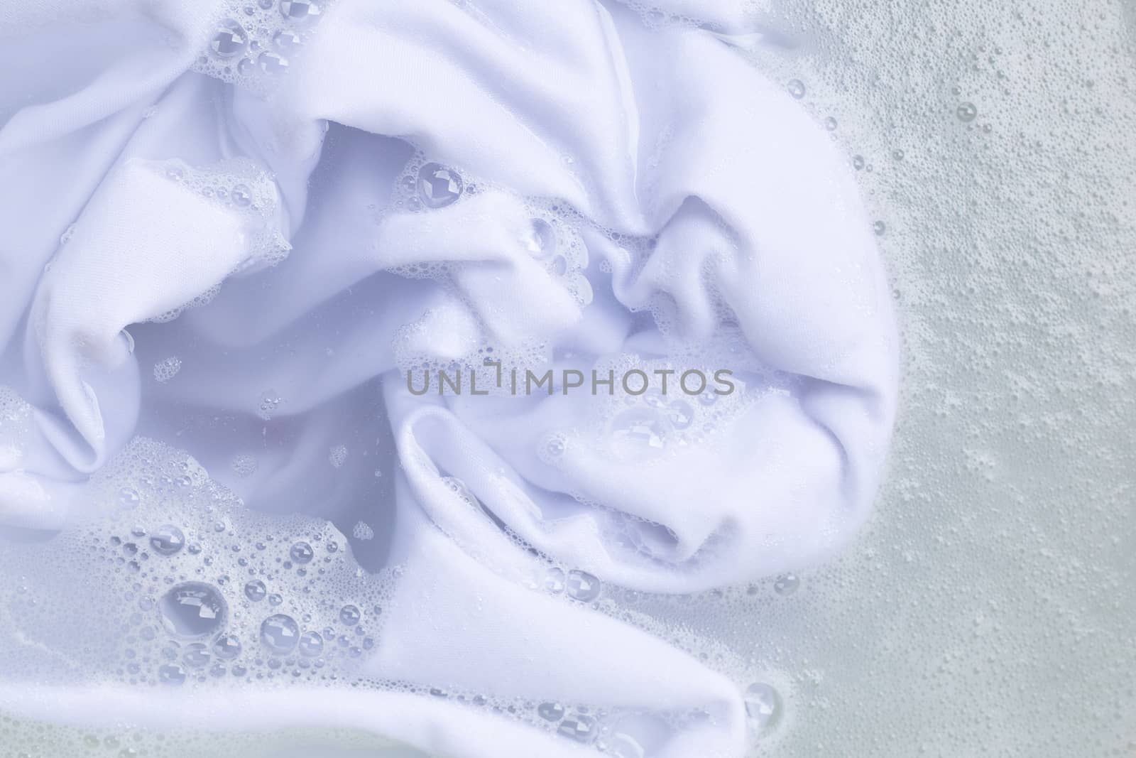 Soak a cloth before washing, white cloth. Top view