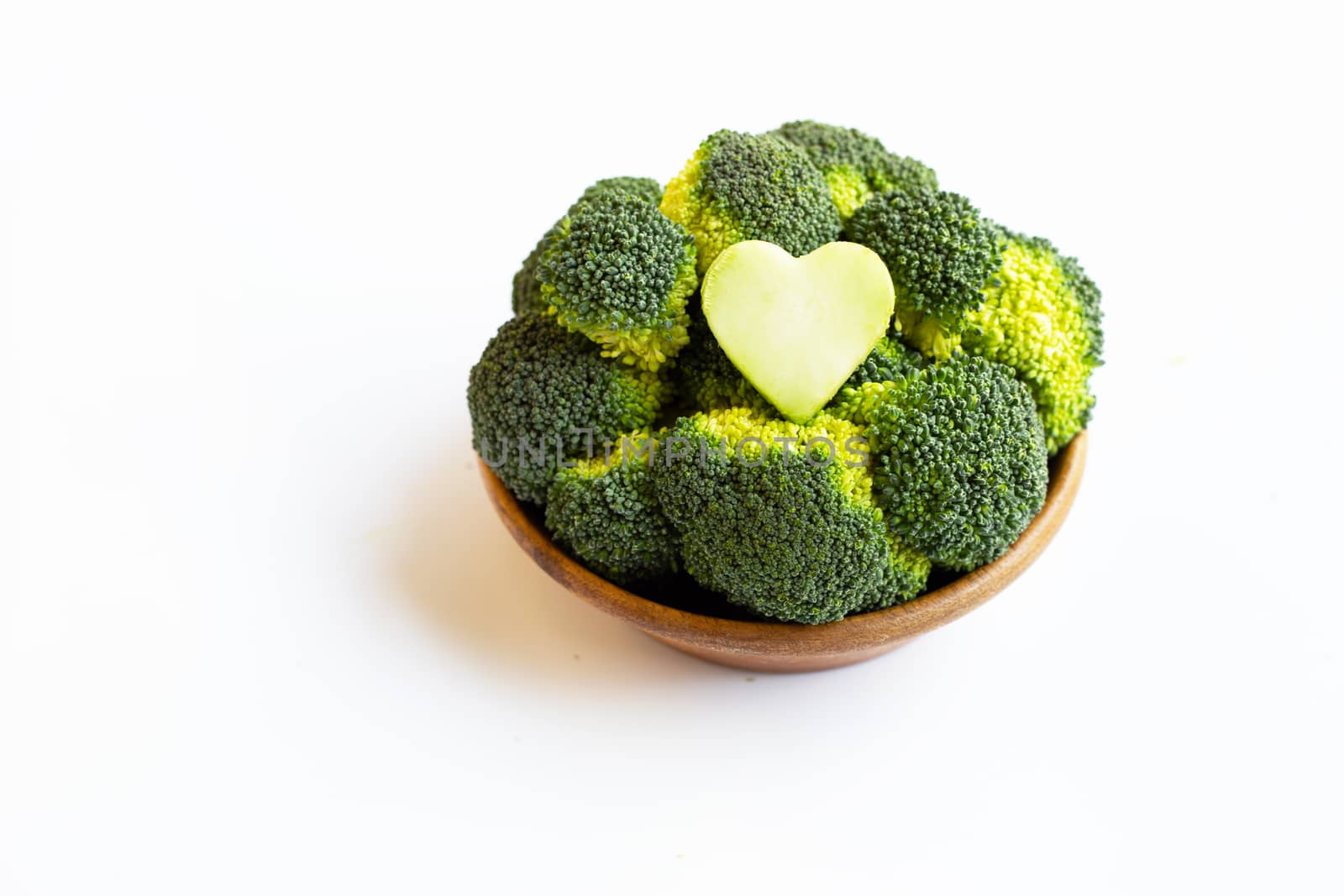 Broccoli in wooden bowl on white by Bowonpat