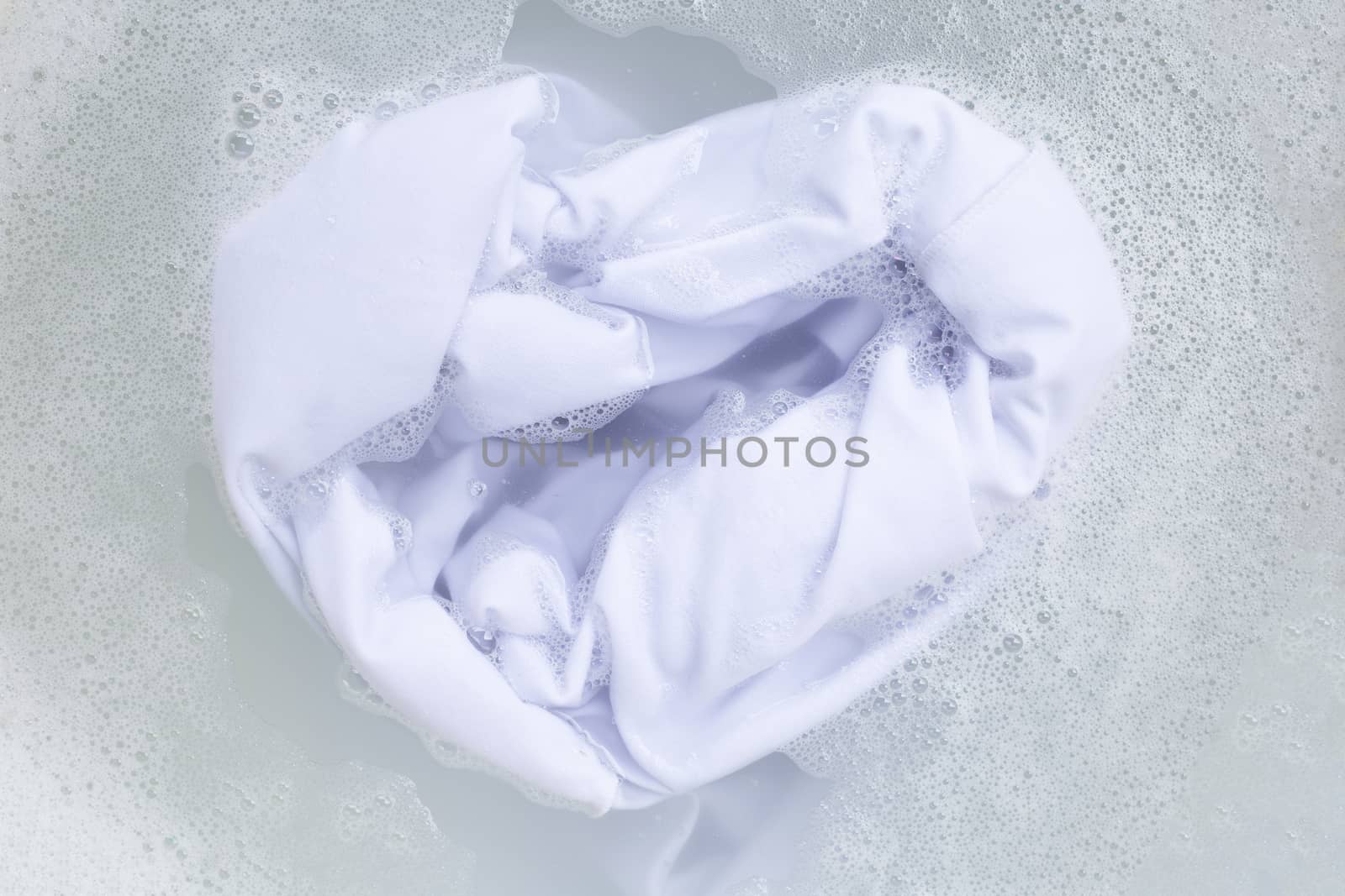 Soak a cloth before washing, white cloth by Bowonpat