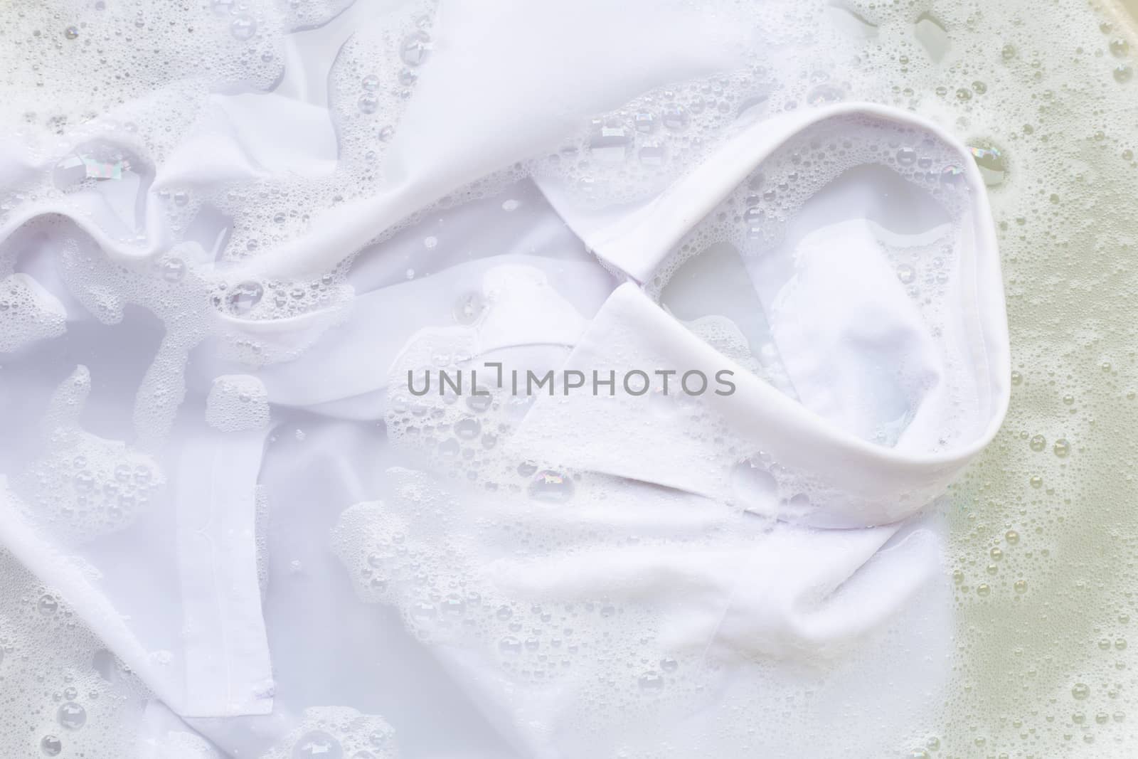 Soak a cloth before washing, white shirt