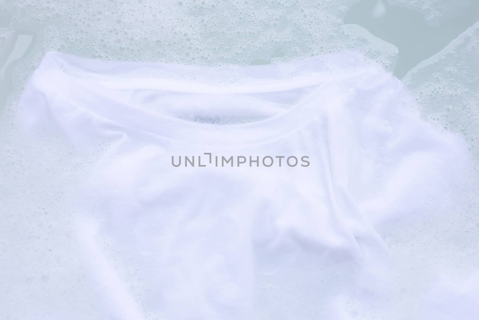 Soak cloth before washing, white t-shirt by Bowonpat
