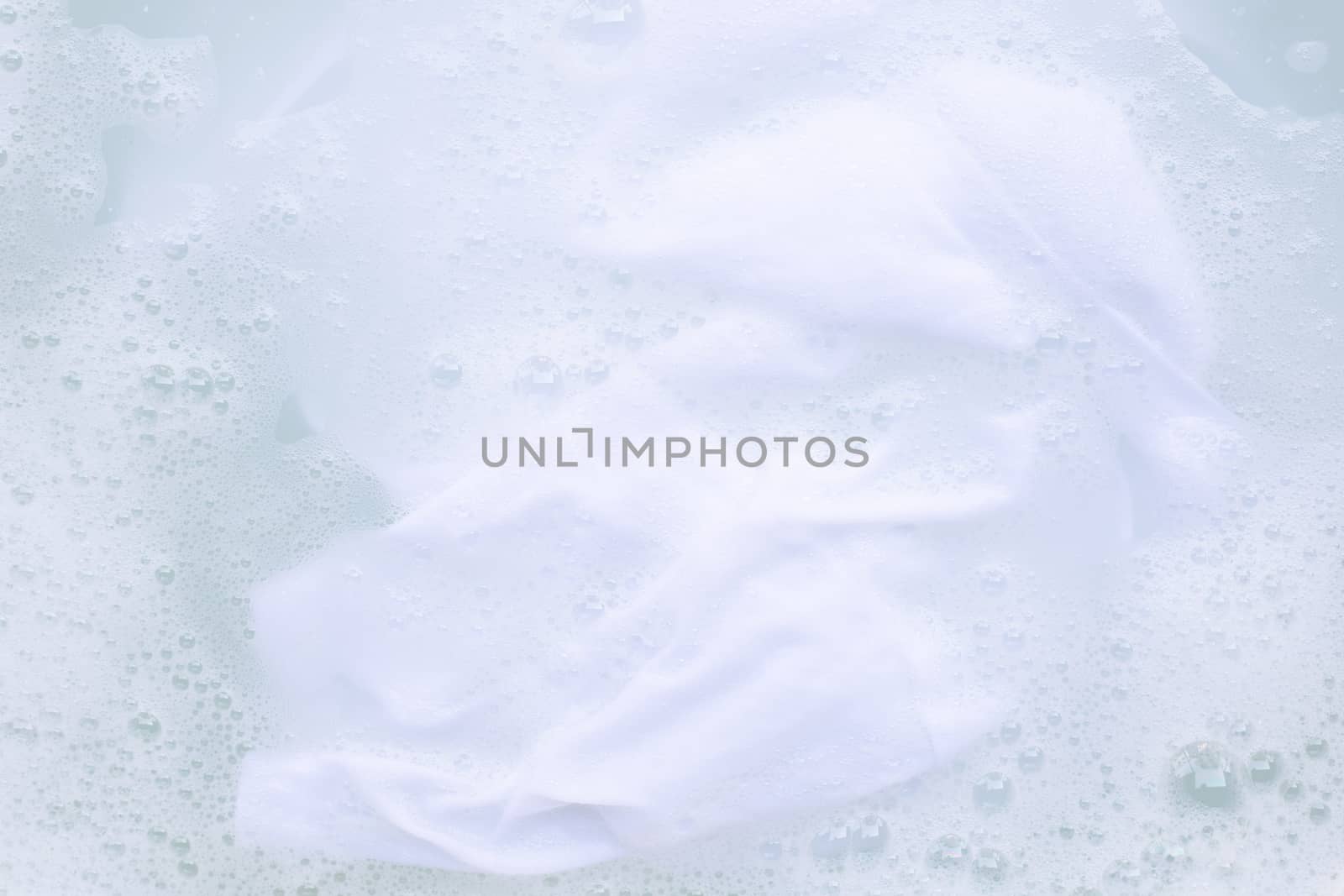 Soak  cloth before washing, white cloth by Bowonpat