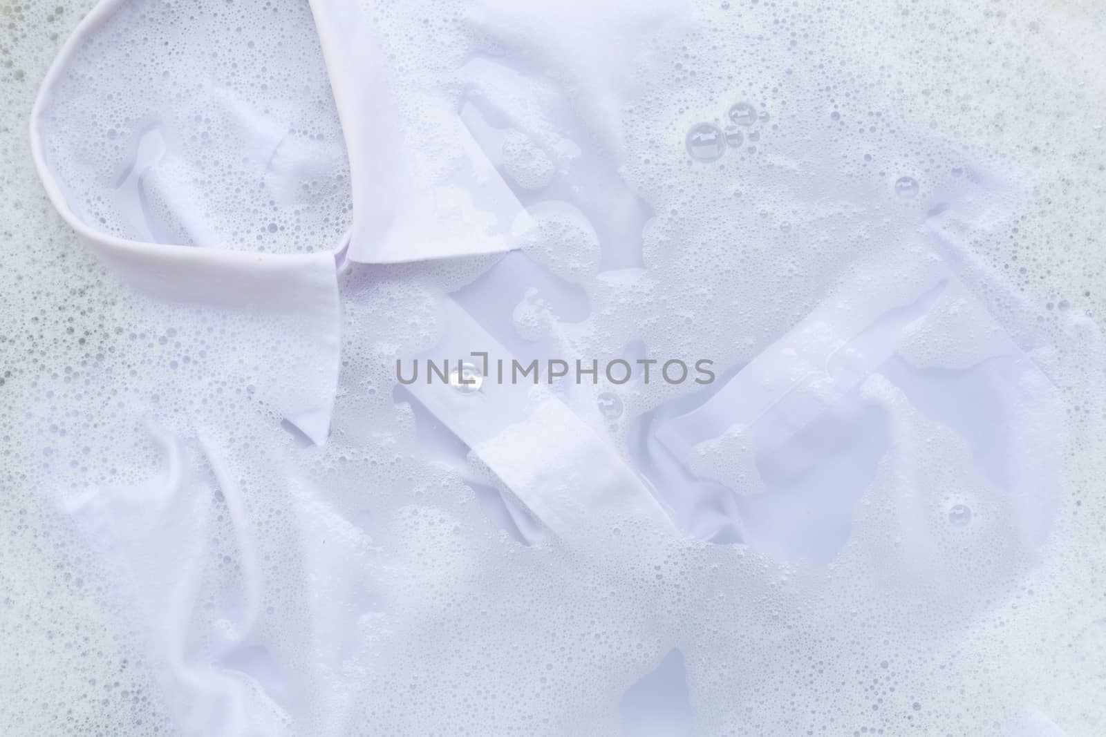 Soak  cloth before washing, white shirt by Bowonpat