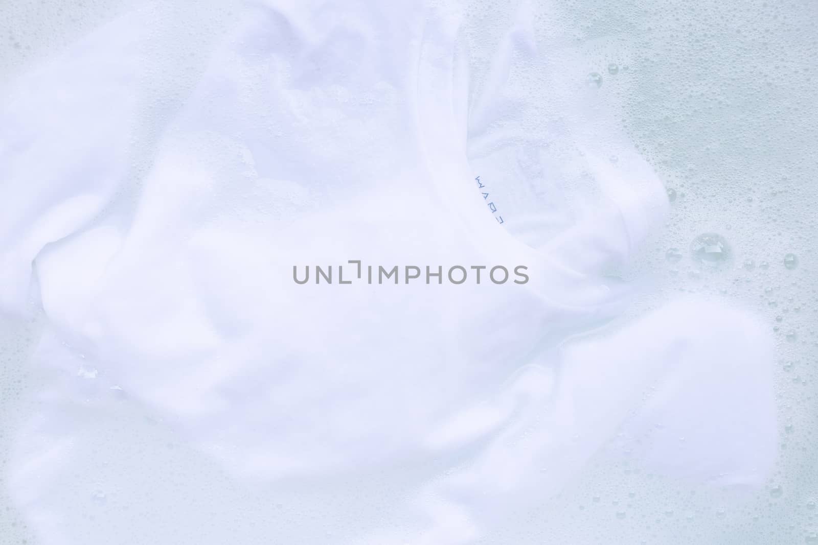 Soak cloth before washing, white t-shirt by Bowonpat