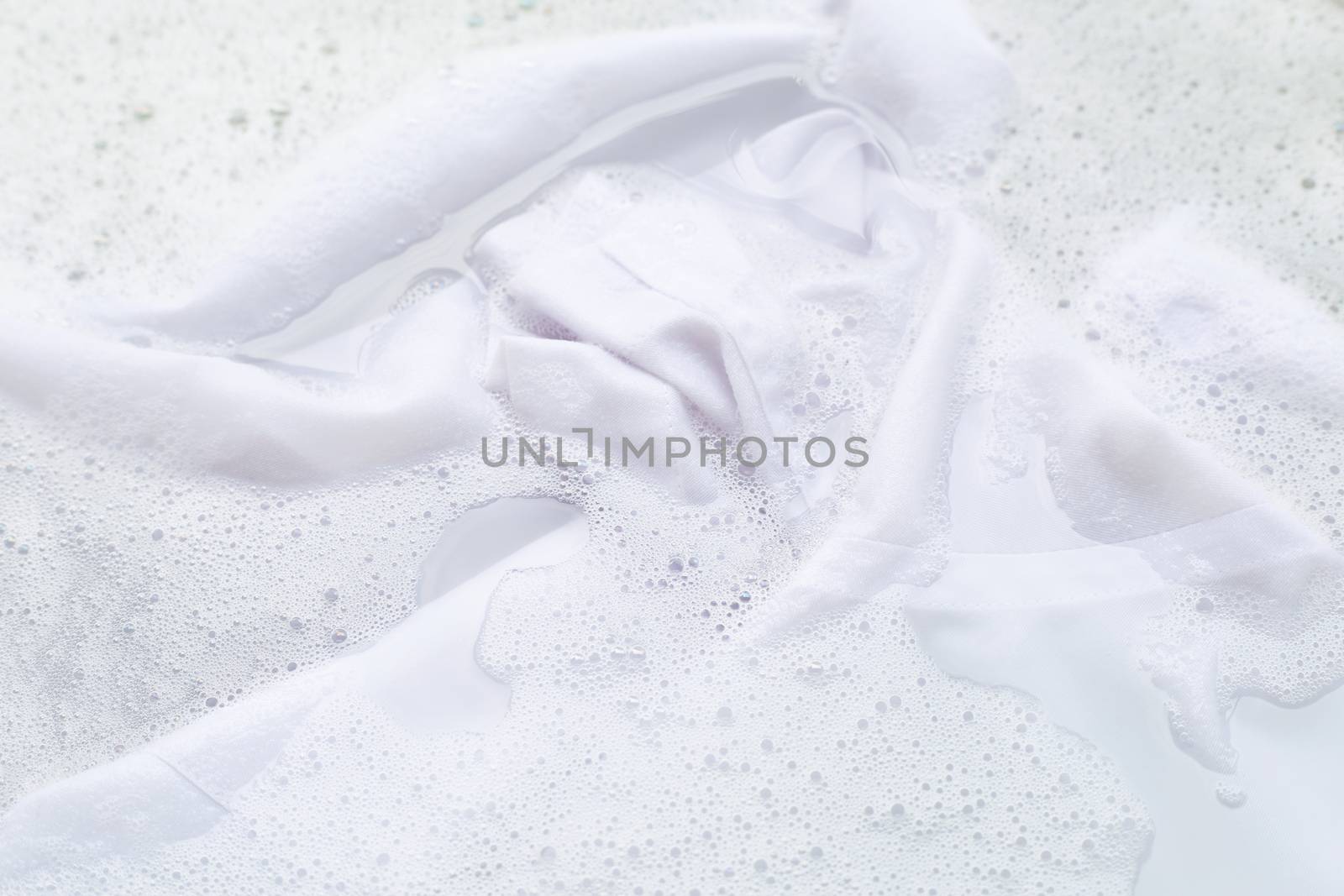 Soak  cloth before washing, white shirt by Bowonpat