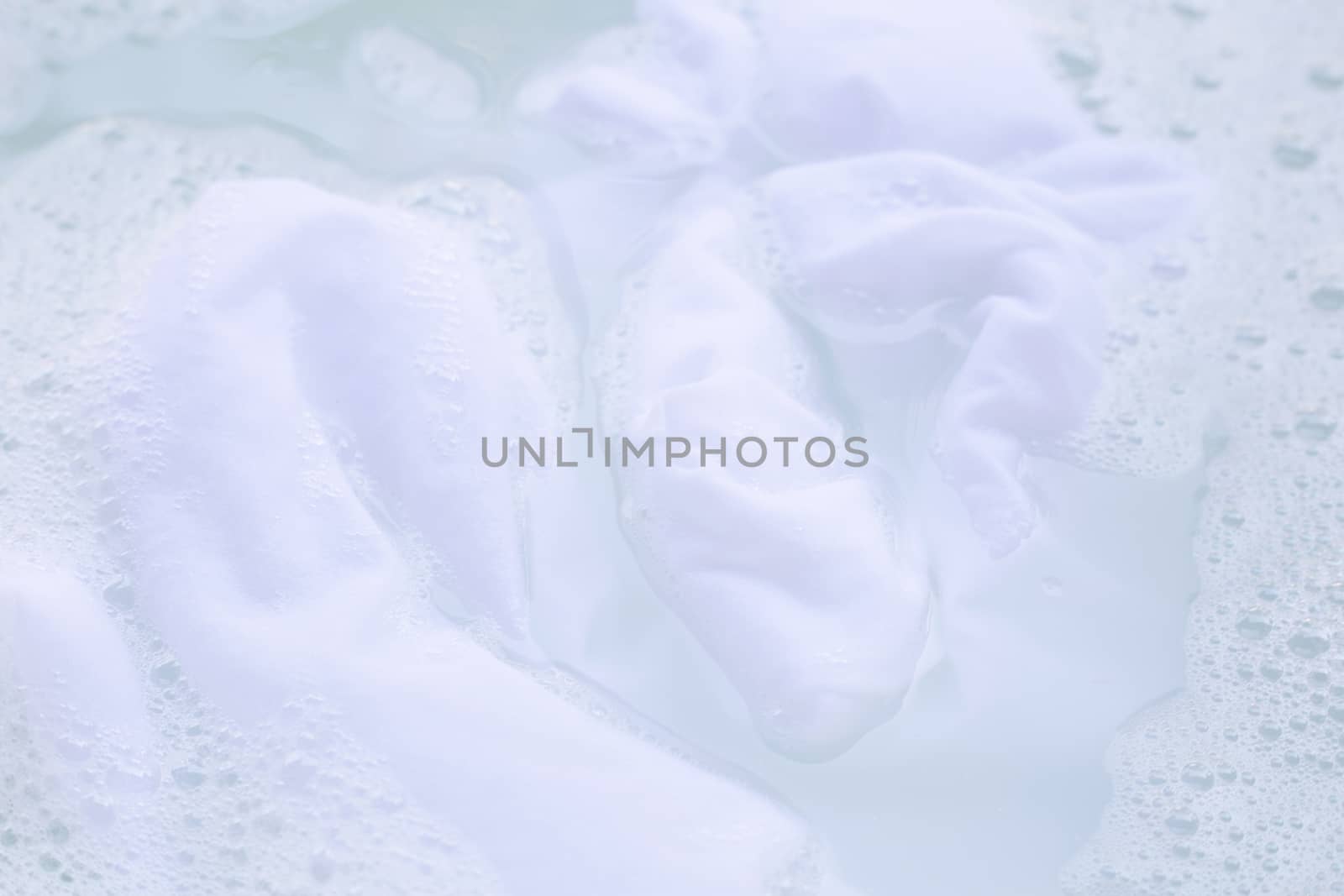 Soak  cloth before washing, white cloth by Bowonpat