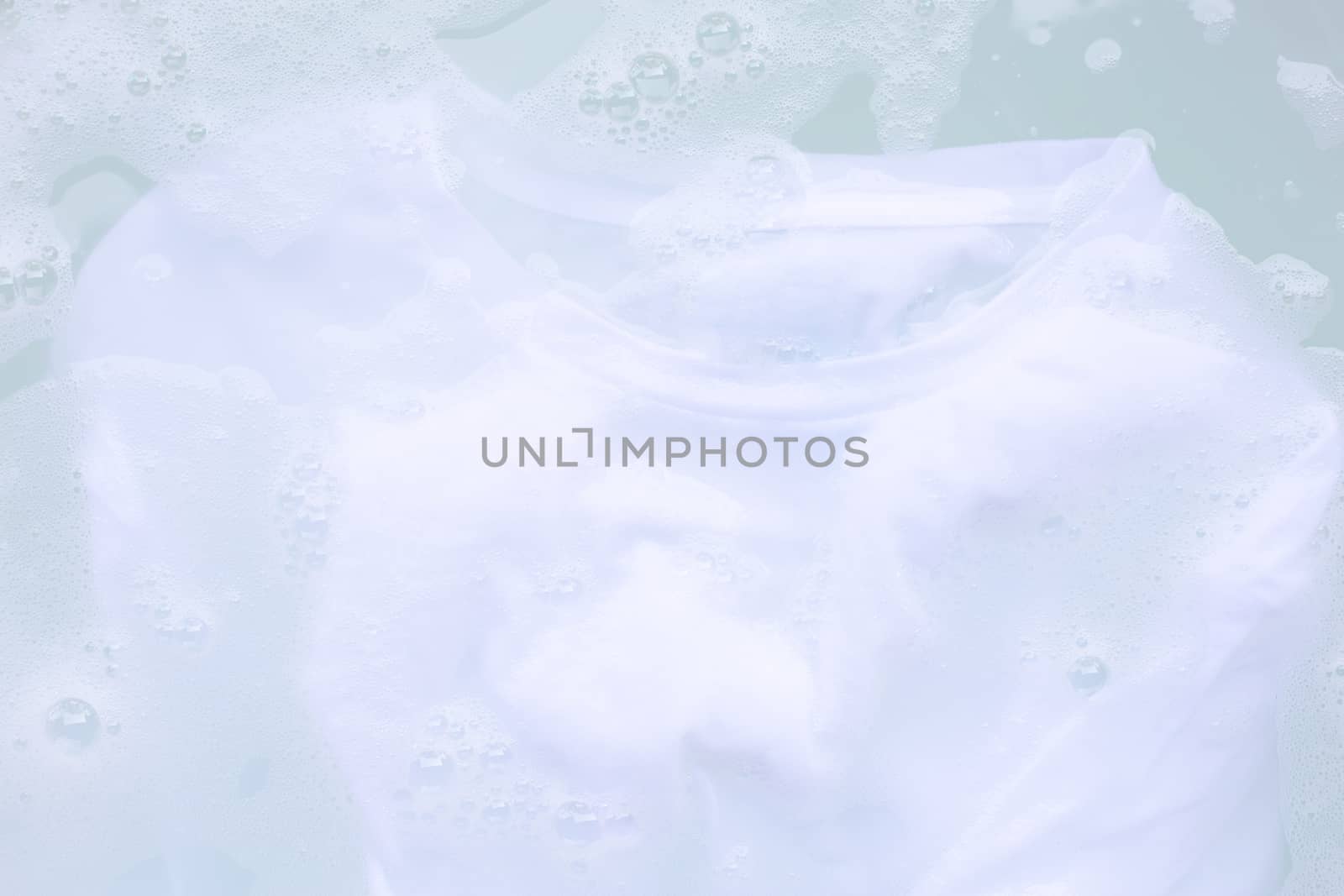 Soak cloth before washing, white t-shirt by Bowonpat