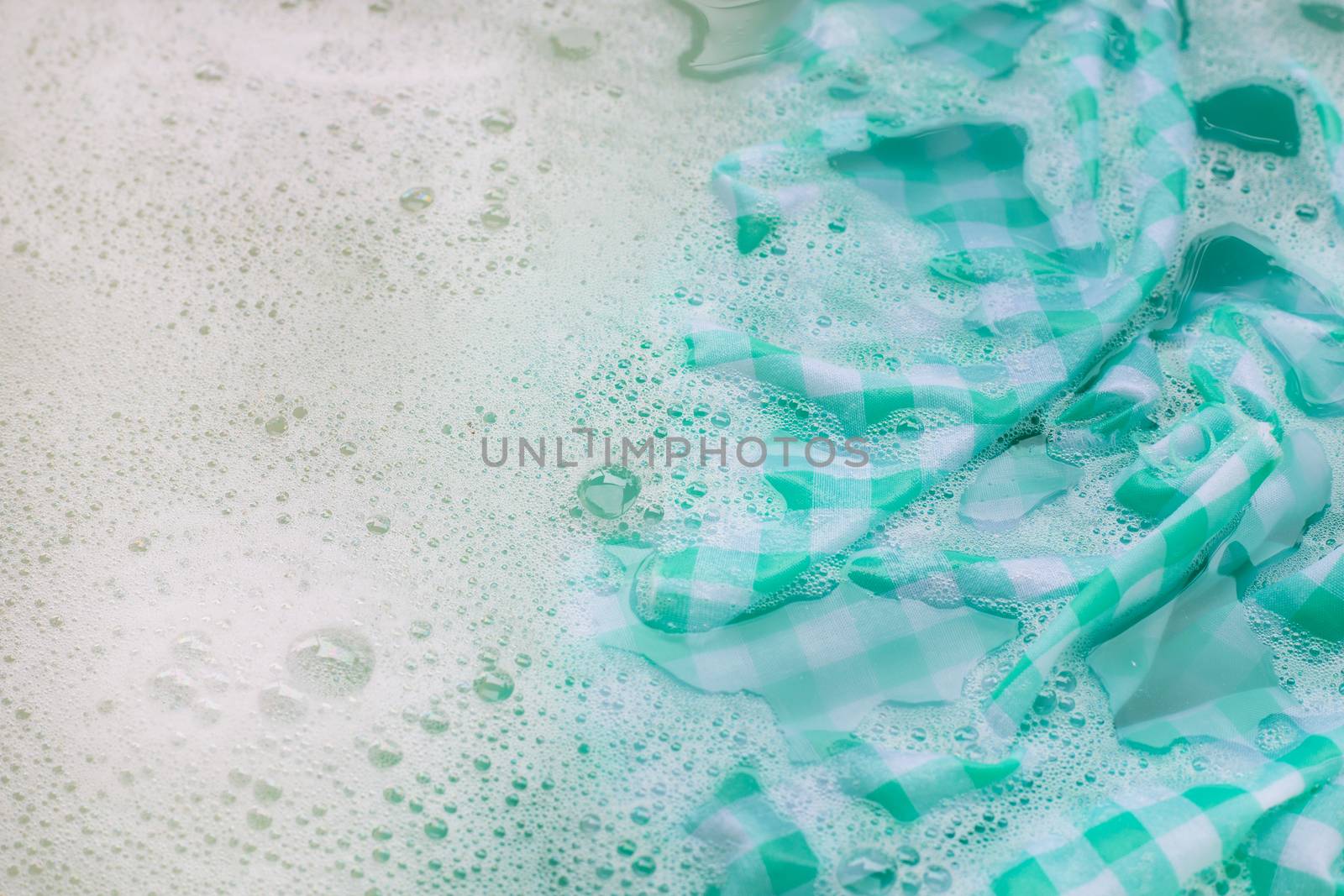 Soak green white tablecloth before washing. by Bowonpat