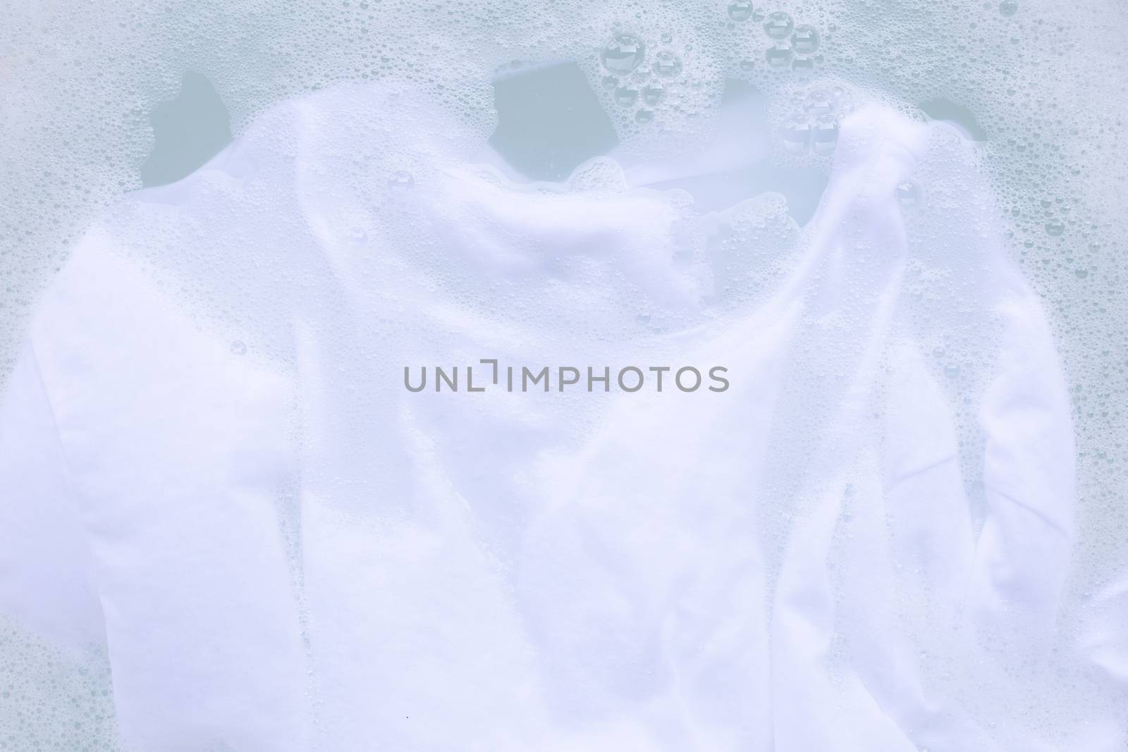 Soak cloth before washing, white t-shirt by Bowonpat