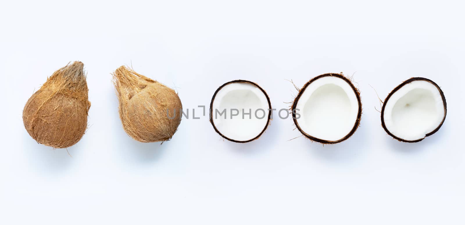 Ripe coconuts on white. Top view of tropical fruit. by Bowonpat