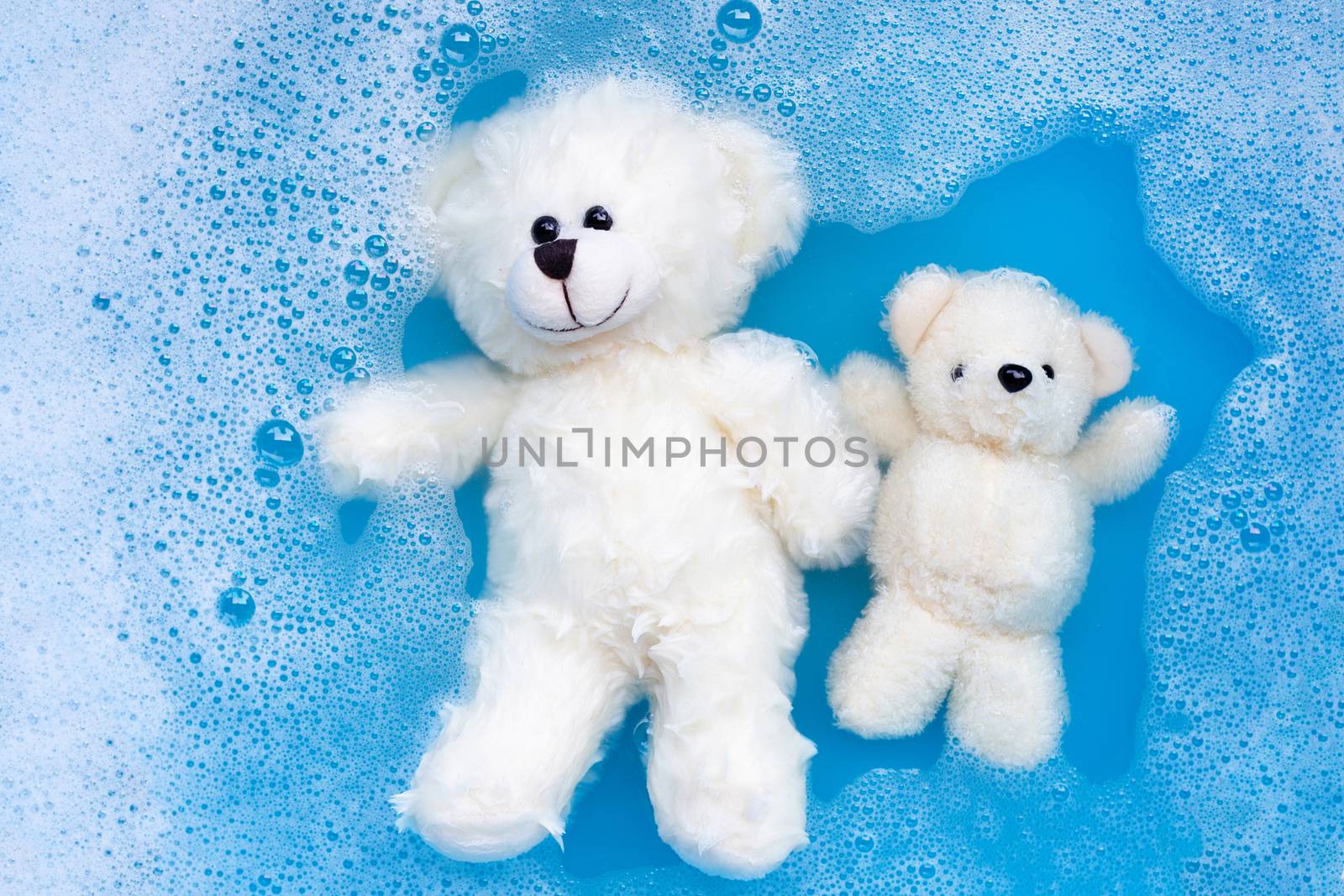 Soak toy bears in laundry detergent water dissolution before was by Bowonpat