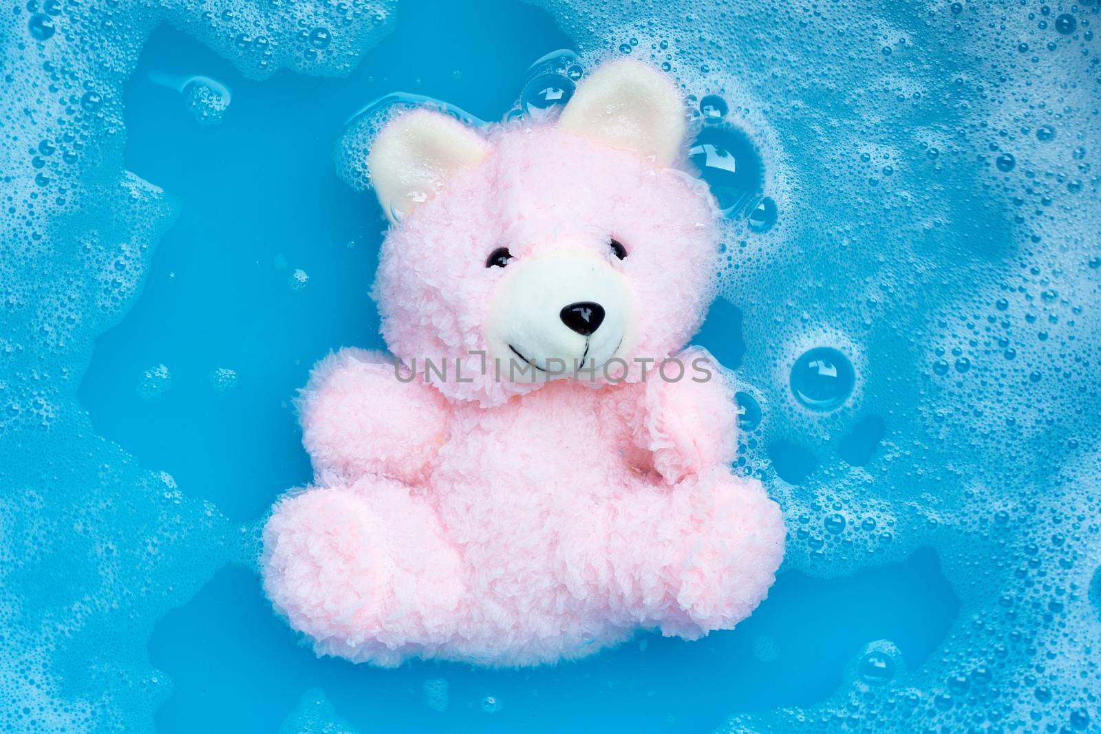 Soak  toy bear in laundry detergent water dissolution before was by Bowonpat