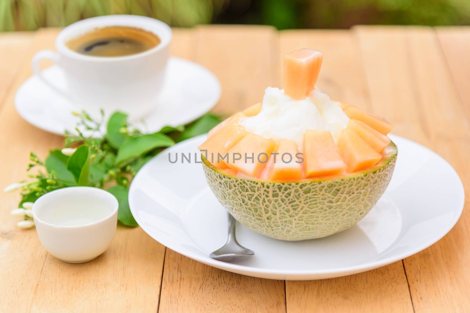 Melon Bingsu with Sweetened Condensed Milk on wood table by rukawajung