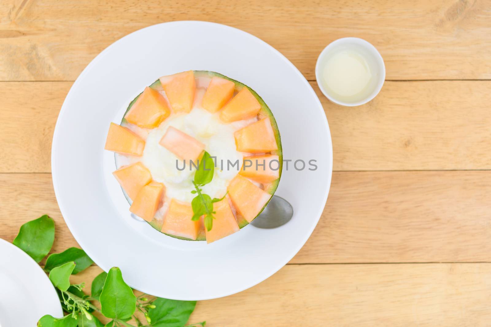 Melon Bingsu with Sweetened Condensed Milk on wood table by rukawajung