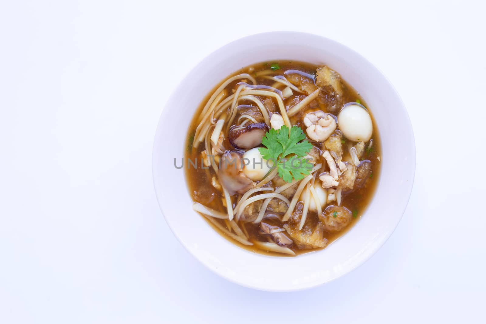 Braised fish maw in red gravy in bowl on white background.