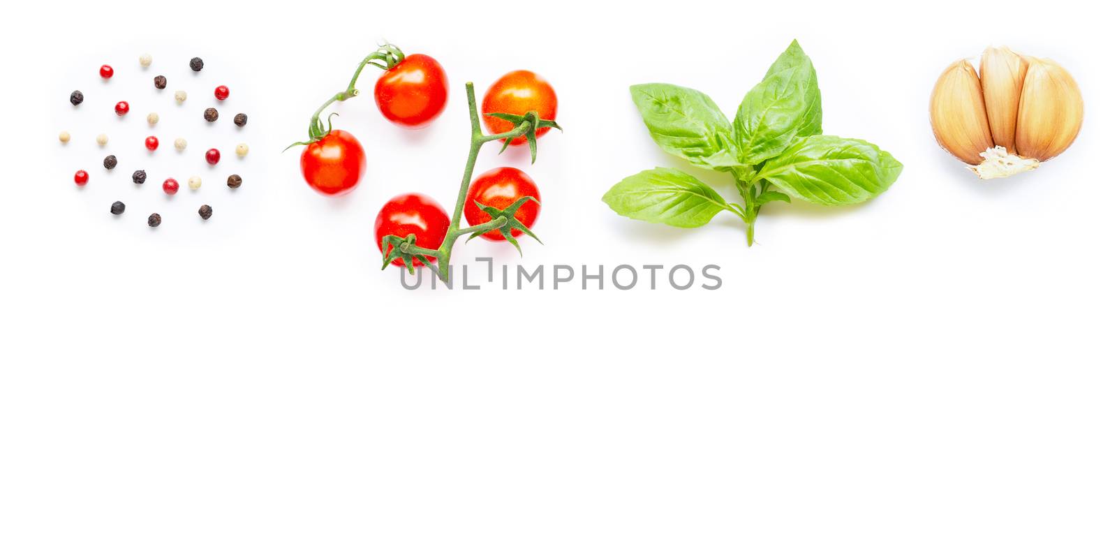 Different type of peppercorns, fresh cherry tomatoes, basil leaves and garlic  on white background. Copy space