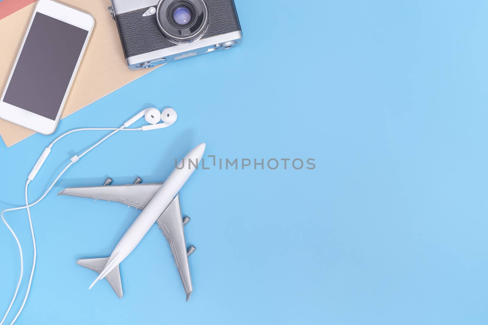 Plane and travel objects on blue copy space for poster